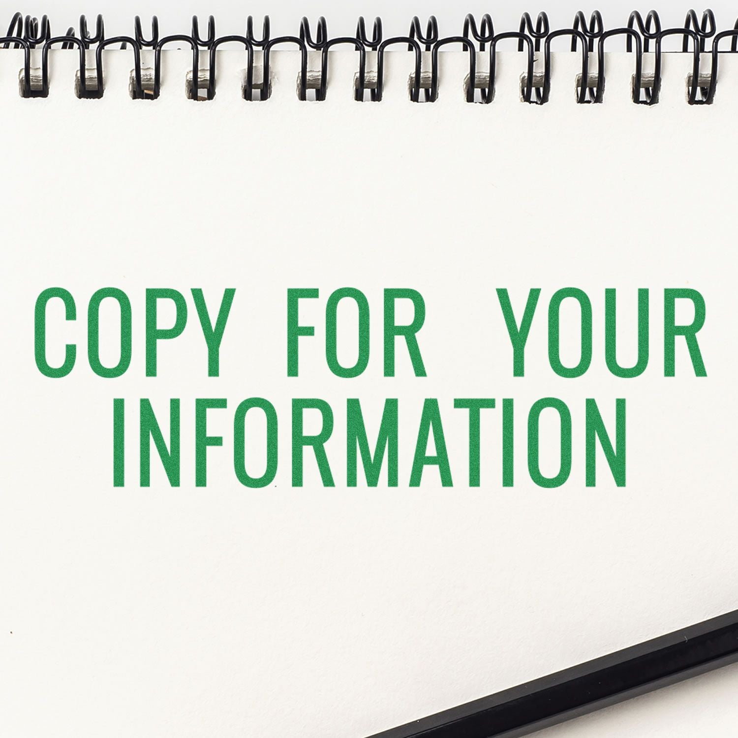 Large Self Inking Narrow Copy for your Information Stamp in green ink on a white notepad with a black spiral binding at the top.