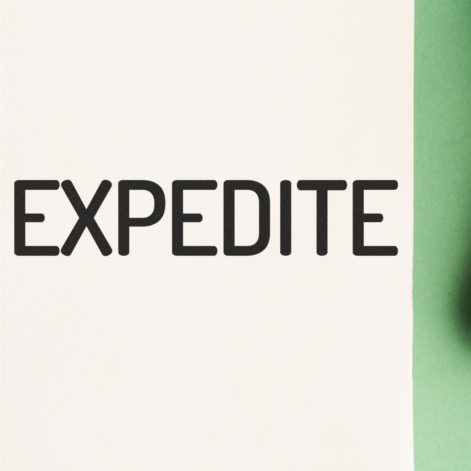 Narrow Expedite Rubber Stamp used to stamp the word 'EXPEDITE' in bold black letters on a white paper with a green background."