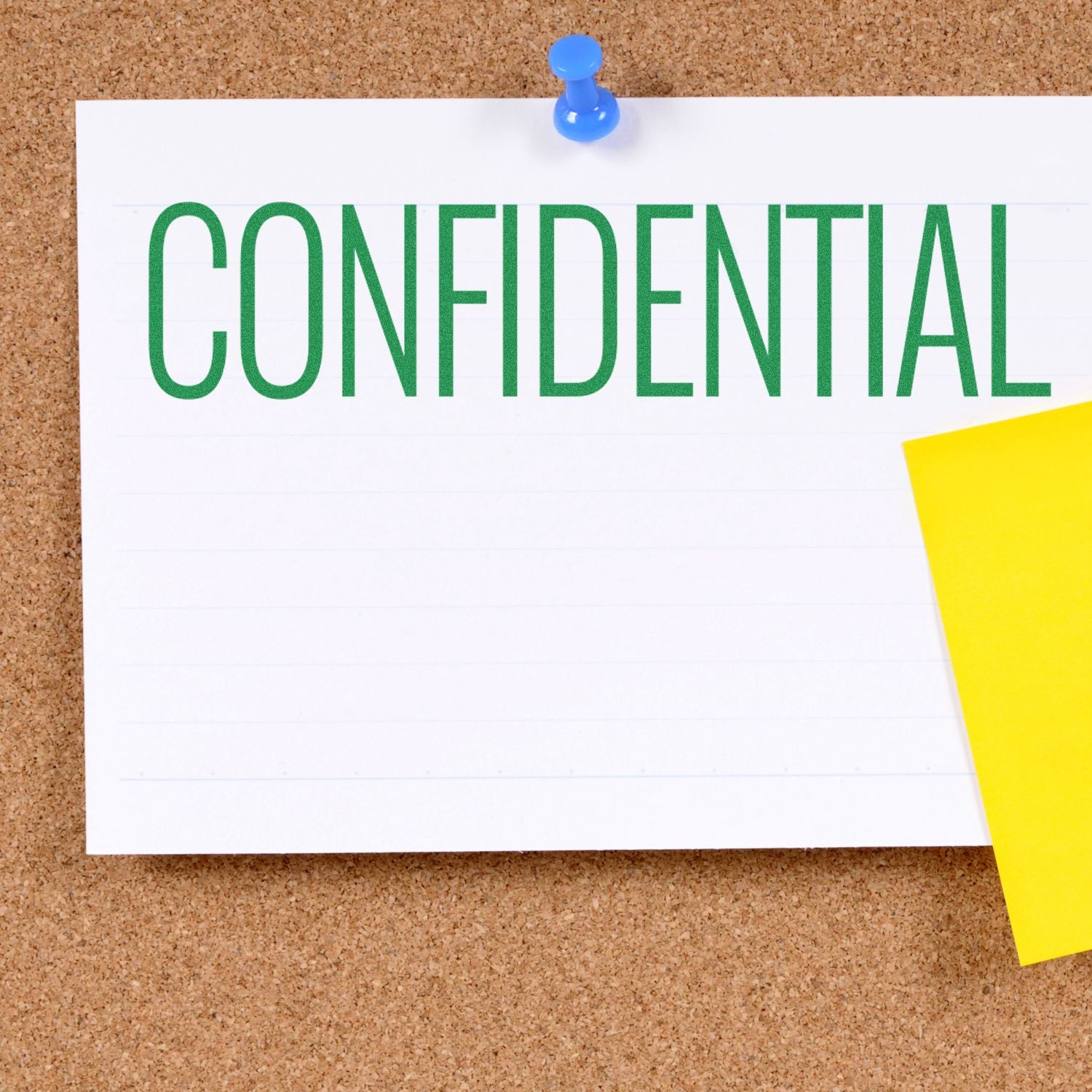 Narrow Font Confidential Rubber Stamp on a white paper pinned to a corkboard with a blue pushpin and a yellow sticky note.