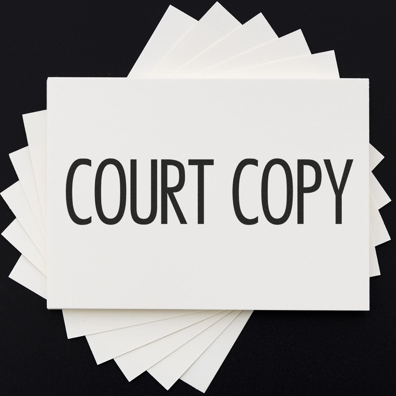 A stack of white cards with COURT COPY stamped in a narrow font, showcasing the Narrow Font Court Copy Rubber Stamp.