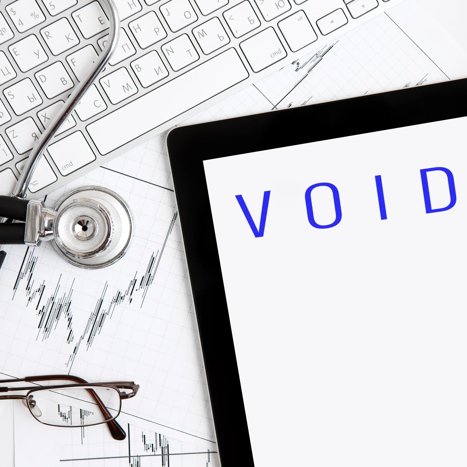 Self Inking Narrow Void Stamp used on a document, placed on a desk with a keyboard, stethoscope, glasses, and tablet displaying VOID .