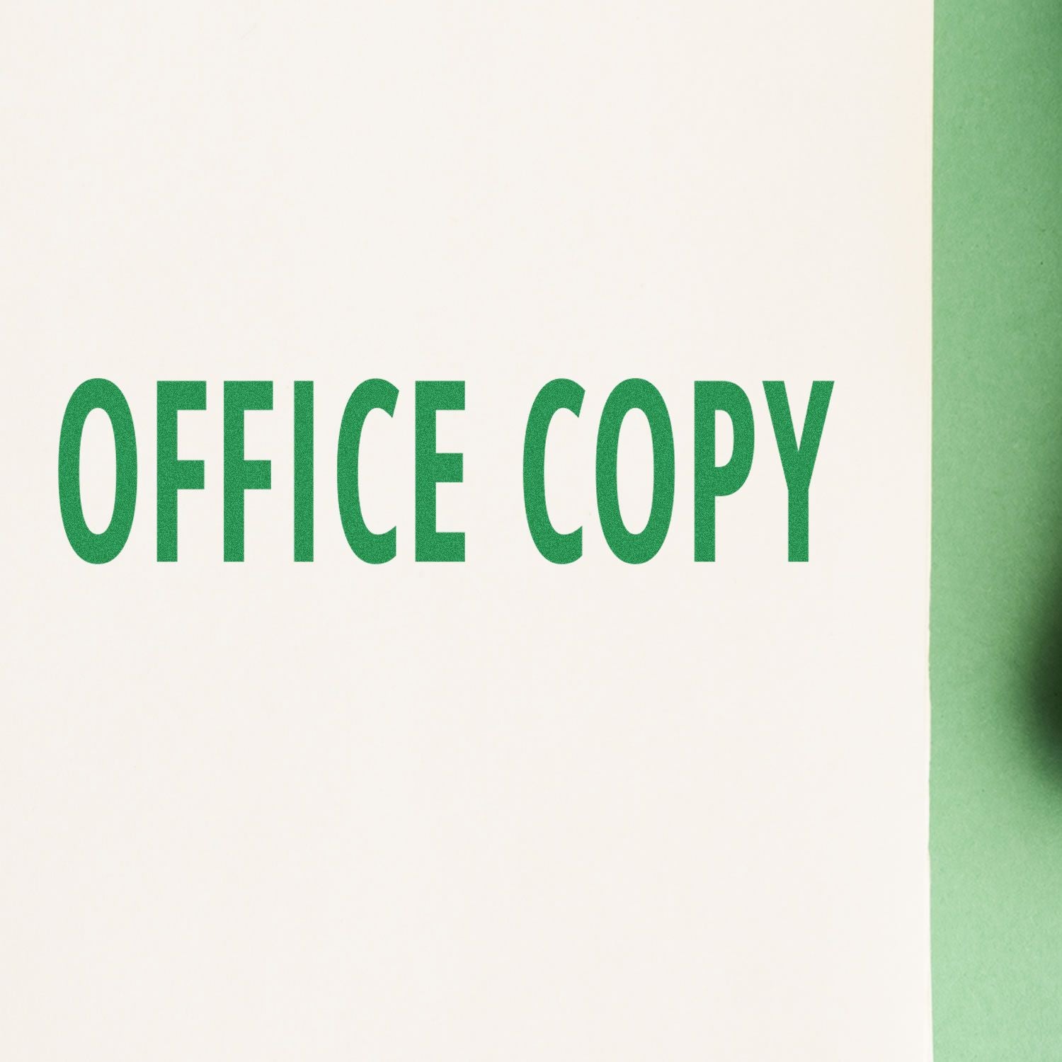 Green 'OFFICE COPY' text stamped on white paper using the Office Copy Rubber Stamp, with a green background on the right side."