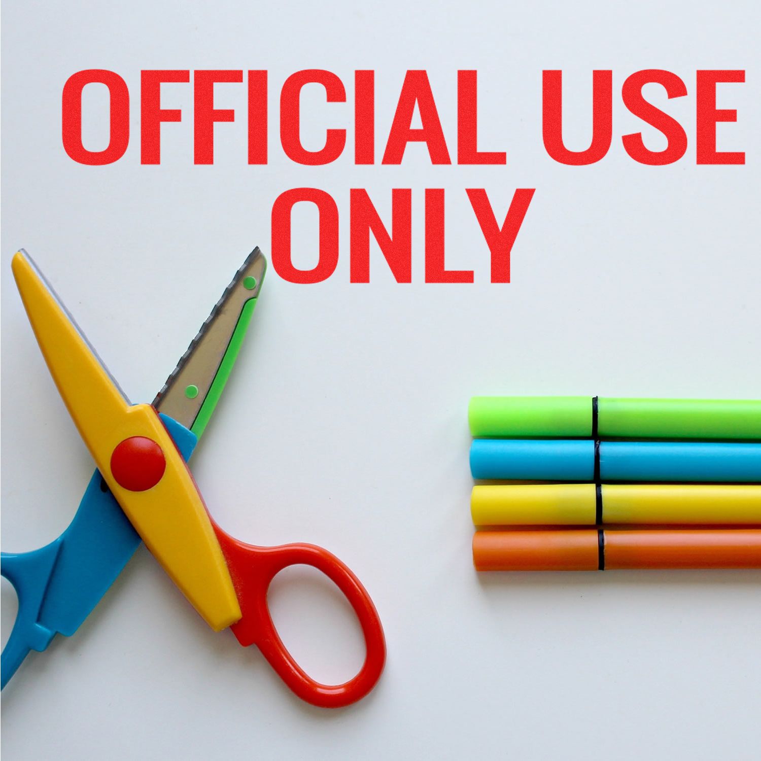 Official Use Only rubber stamp text with colorful scissors and markers on a white background.