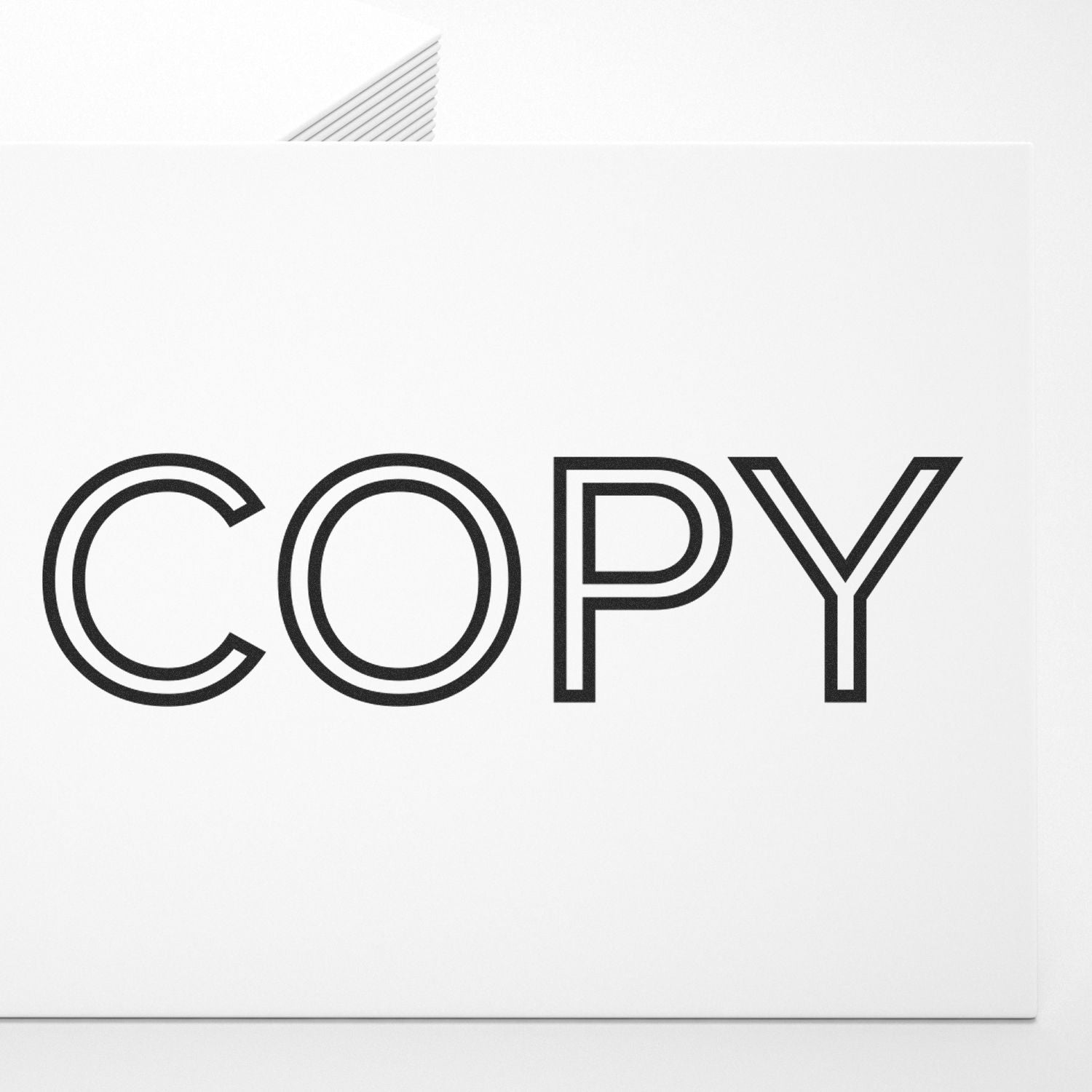 Large Self Inking Outline Font Copy Stamp imprinting the word COPY in bold, black outline font on a white sheet of paper.