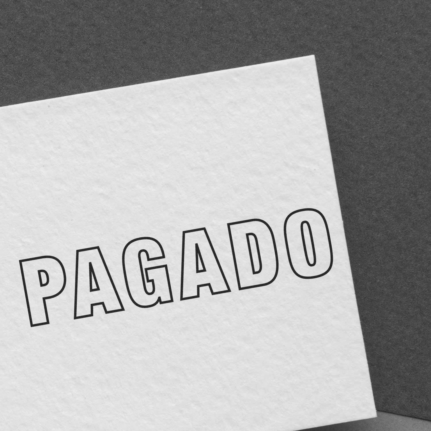 Slim Pre-Inked Outline Pagado Stamp imprint on white paper, showcasing clear and bold text on a dark background.