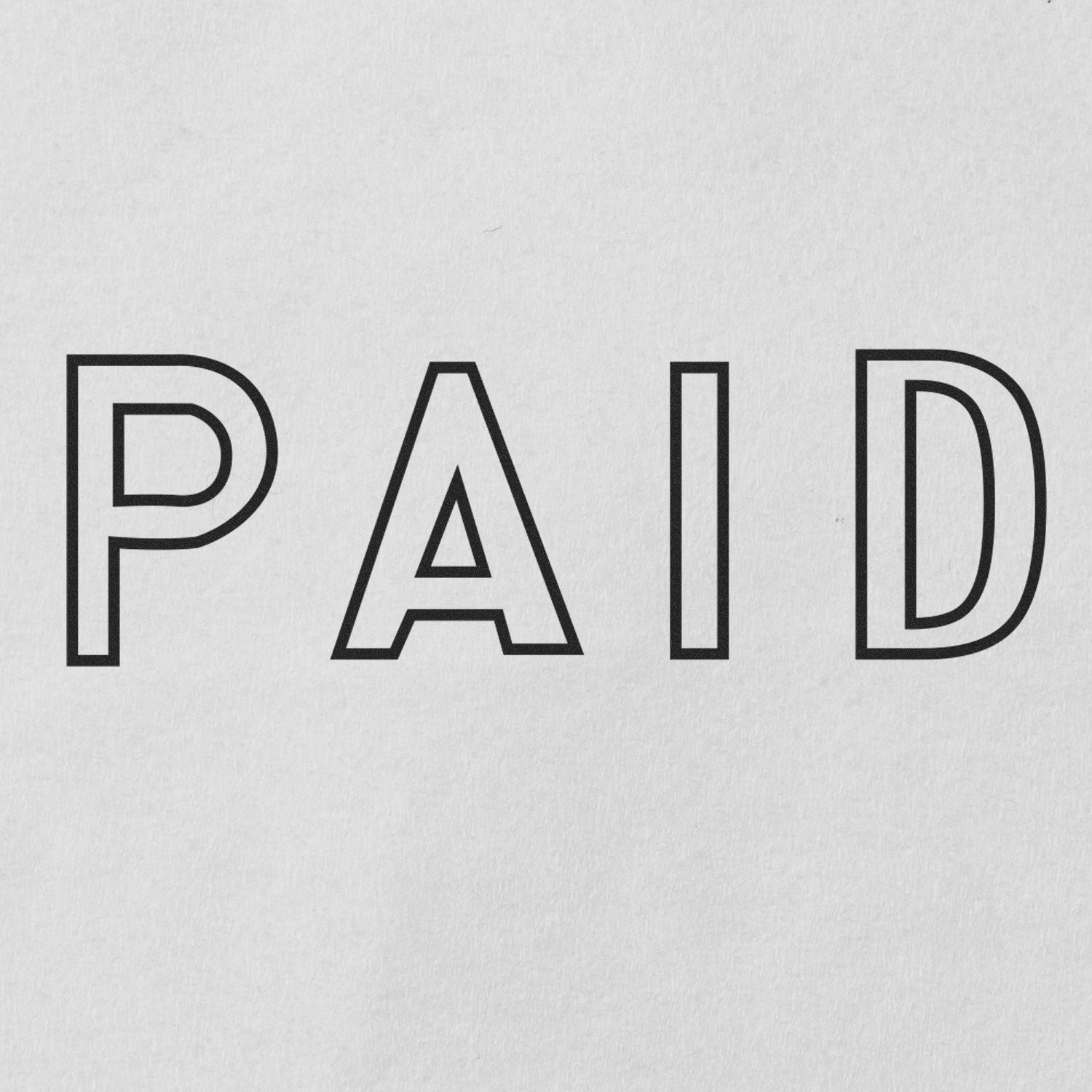 Document stamped with a Slim Pre-Inked Outline Paid Stamp showing the word 'PAID' in bold outline letters on white paper.