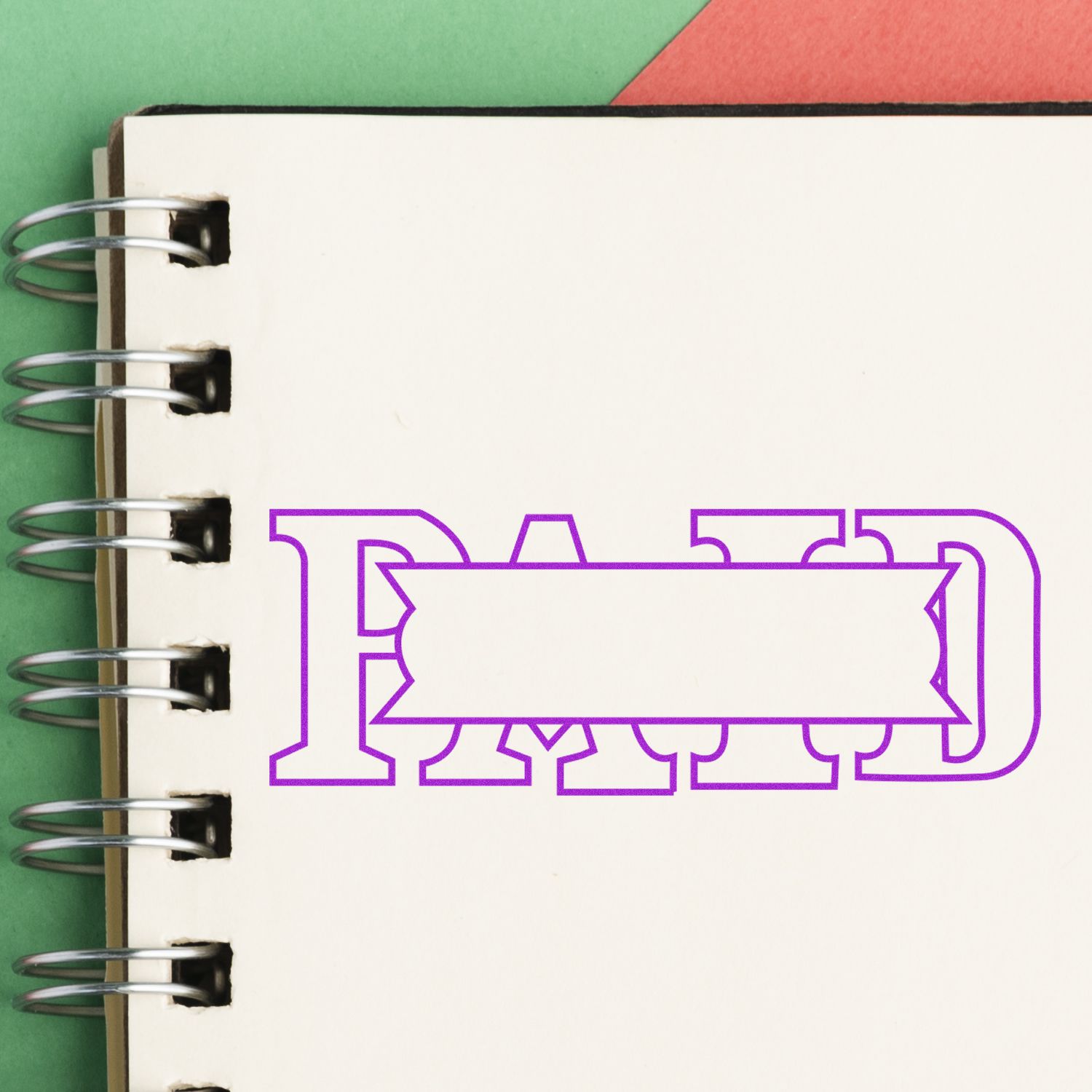 Large Self Inking Paid with Box Stamp imprint on a spiral notebook, showing the word PAID in purple with a blank box in the center.