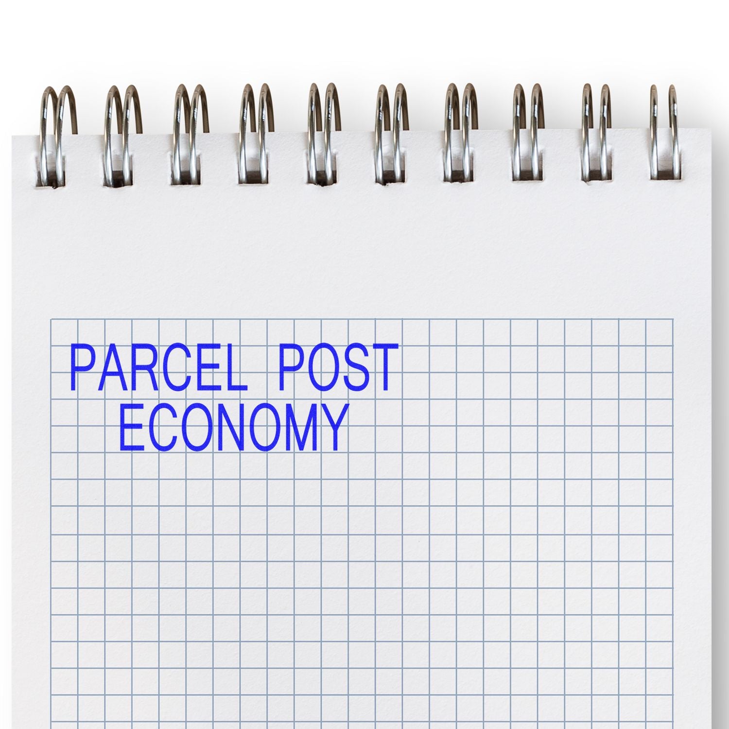 Slim Pre-Inked Parcel Post Economy Stamp used on a spiral notebook with a grid pattern, displaying blue text reading PARCEL POST ECONOMY .