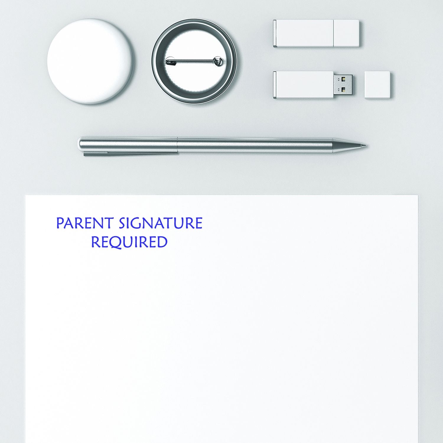 A paper stamped with Parent Signature Required using the Self Inking Parent Signature Required Stamp, surrounded by office supplies.