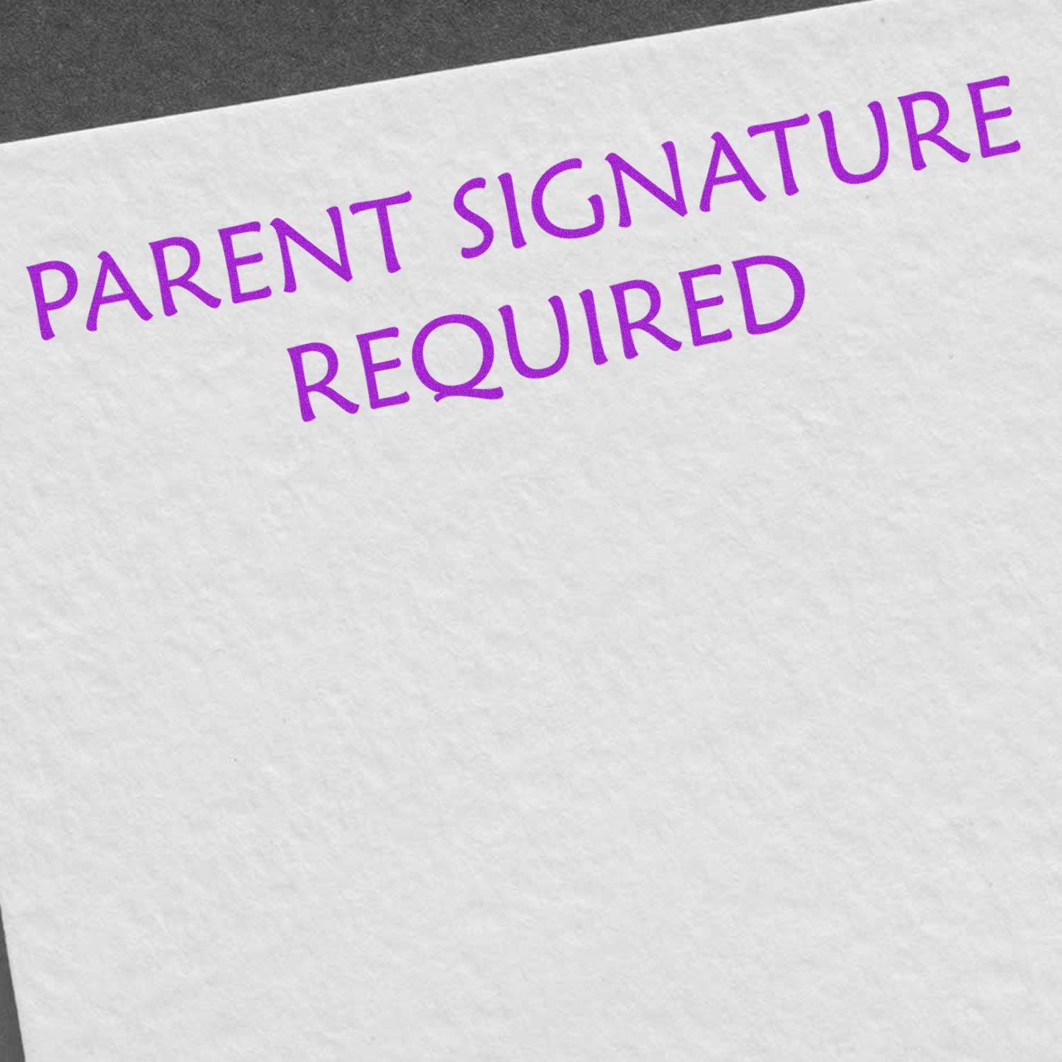 A white paper stamped with PARENT SIGNATURE REQUIRED in purple ink using the Self Inking Parent Signature Required Stamp.