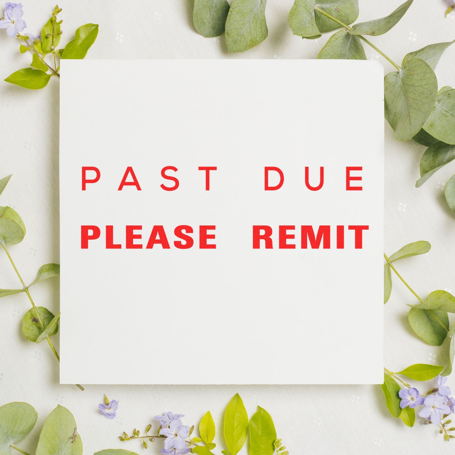 Past Due Please Remit rubber stamp impression on white paper, surrounded by green leaves and small purple flowers.