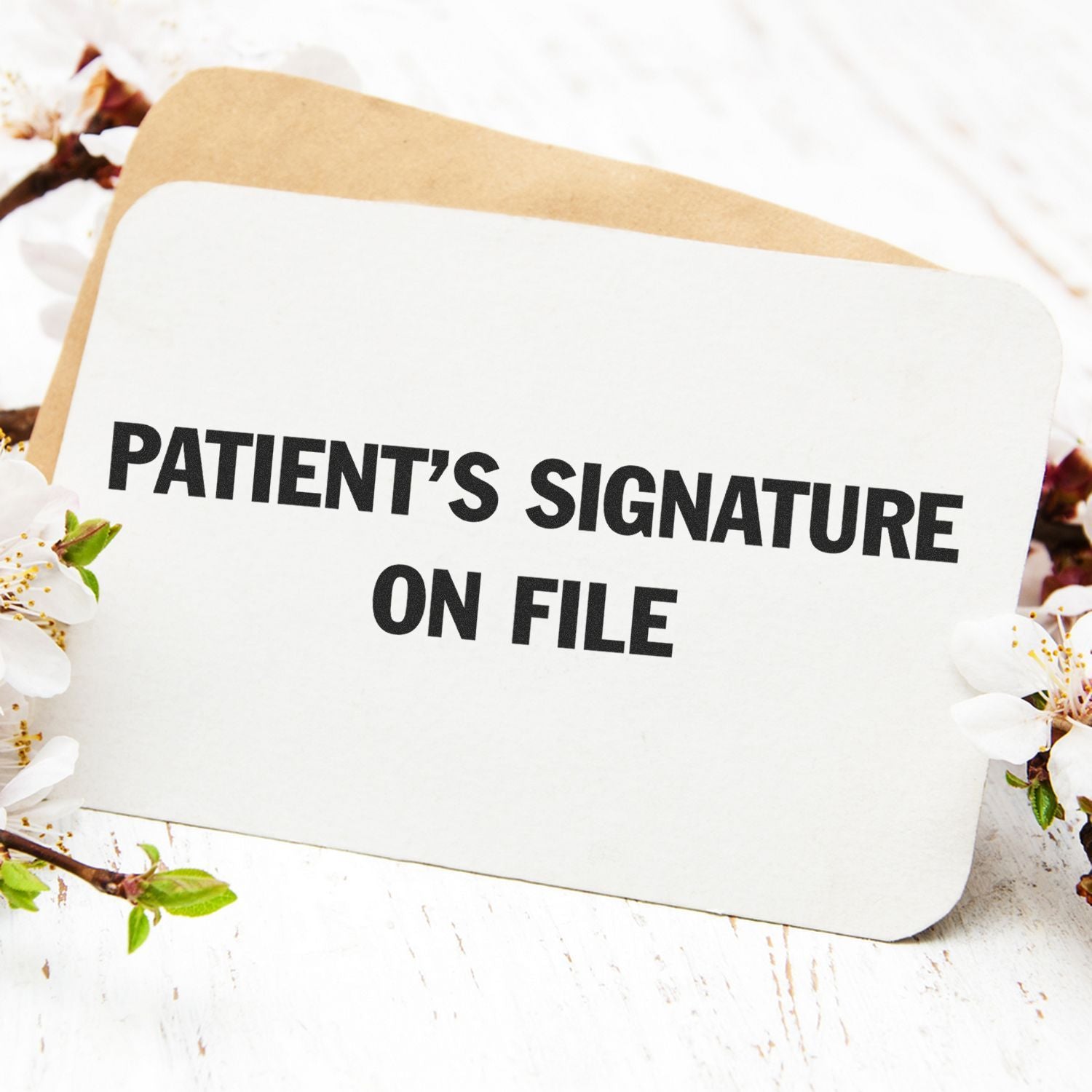 Patient's Signature on File Rubber Stamp on a white card with flowers and a brown envelope in the background.