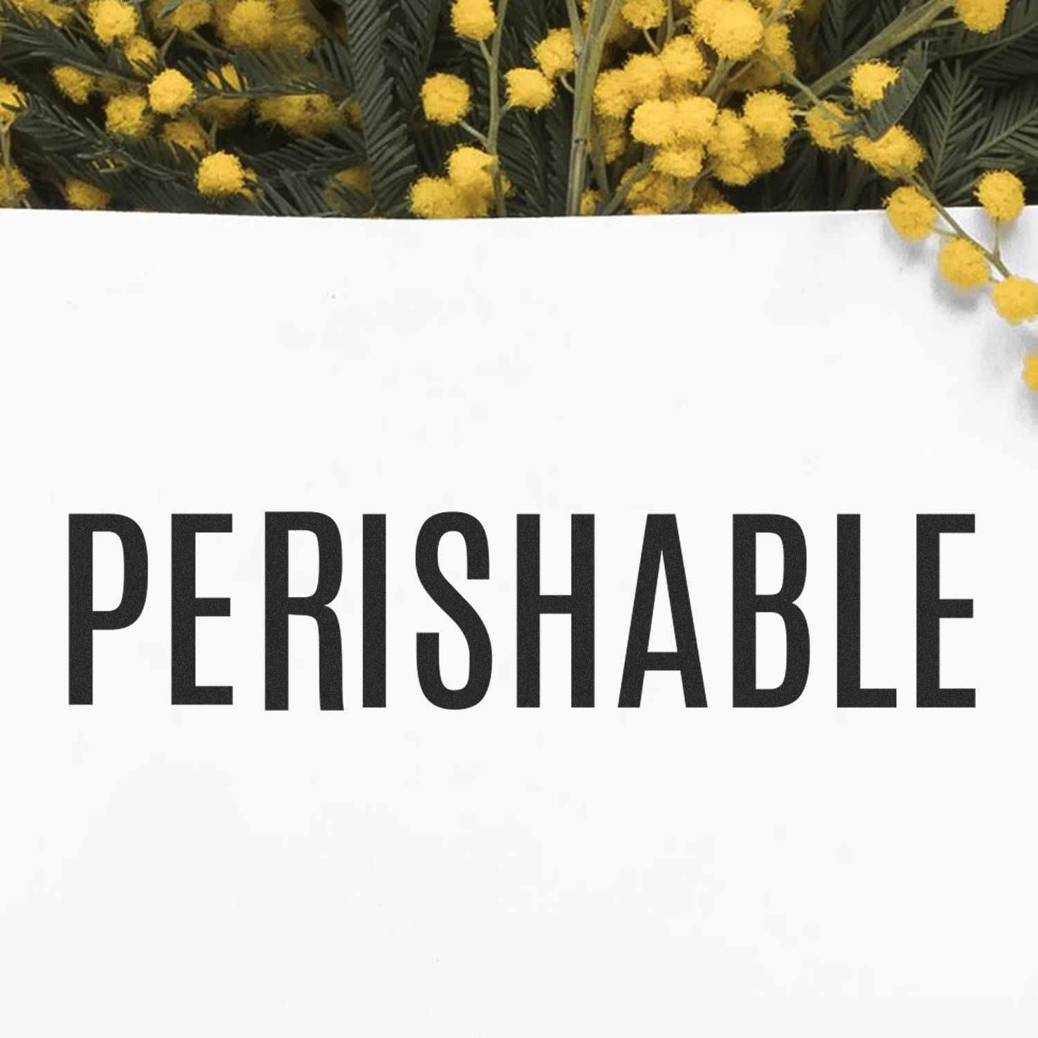 Slim Pre-Inked Perishable Stamp marking 'PERISHABLE' on white paper with yellow flowers in the background.