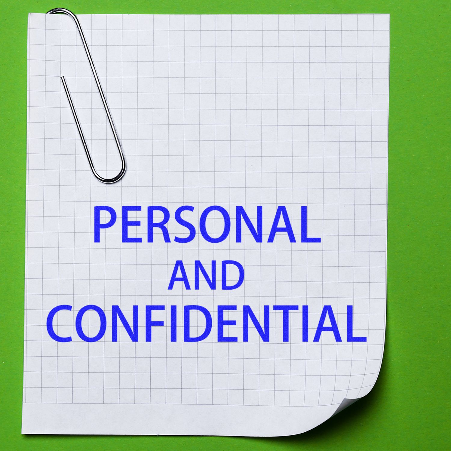 A sheet of graph paper with PERSONAL AND CONFIDENTIAL stamped in blue using the Self Inking Personal Confidential Stamp, clipped with a paperclip.