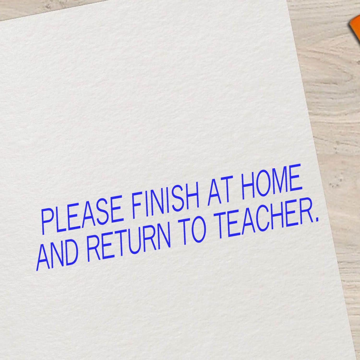 Large Pre-Inked Please Finish At Home And Return Stamp in blue ink on white paper, instructing to complete and return to teacher.