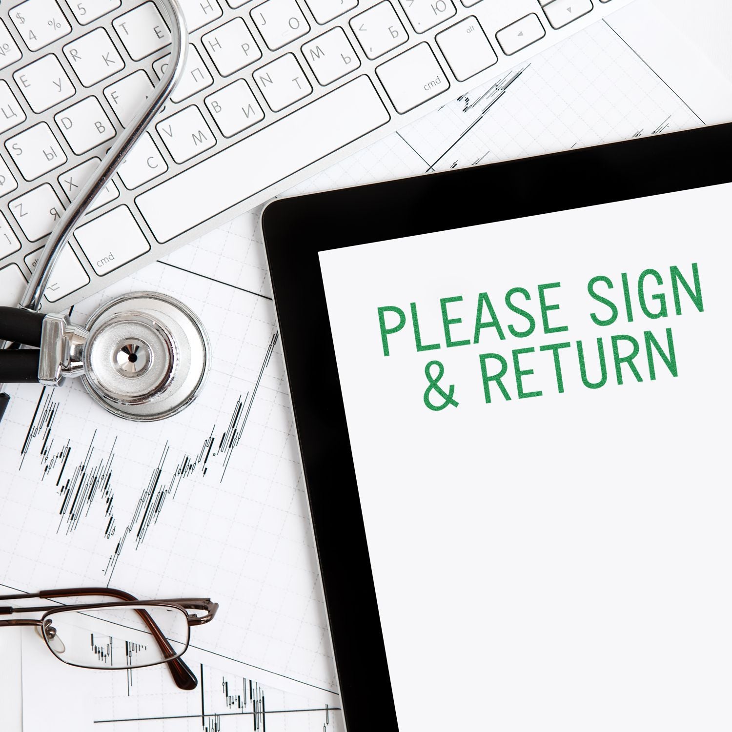 Tablet displaying Please Sign & Return message, surrounded by a keyboard, stethoscope, glasses, and financial charts.