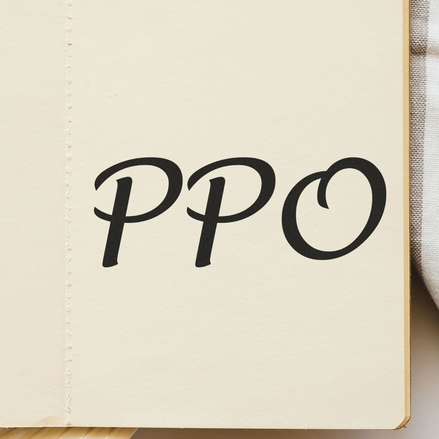 PPO Rubber Stamp impression on an open notebook page, showcasing clear and bold black letters 'PPO'.