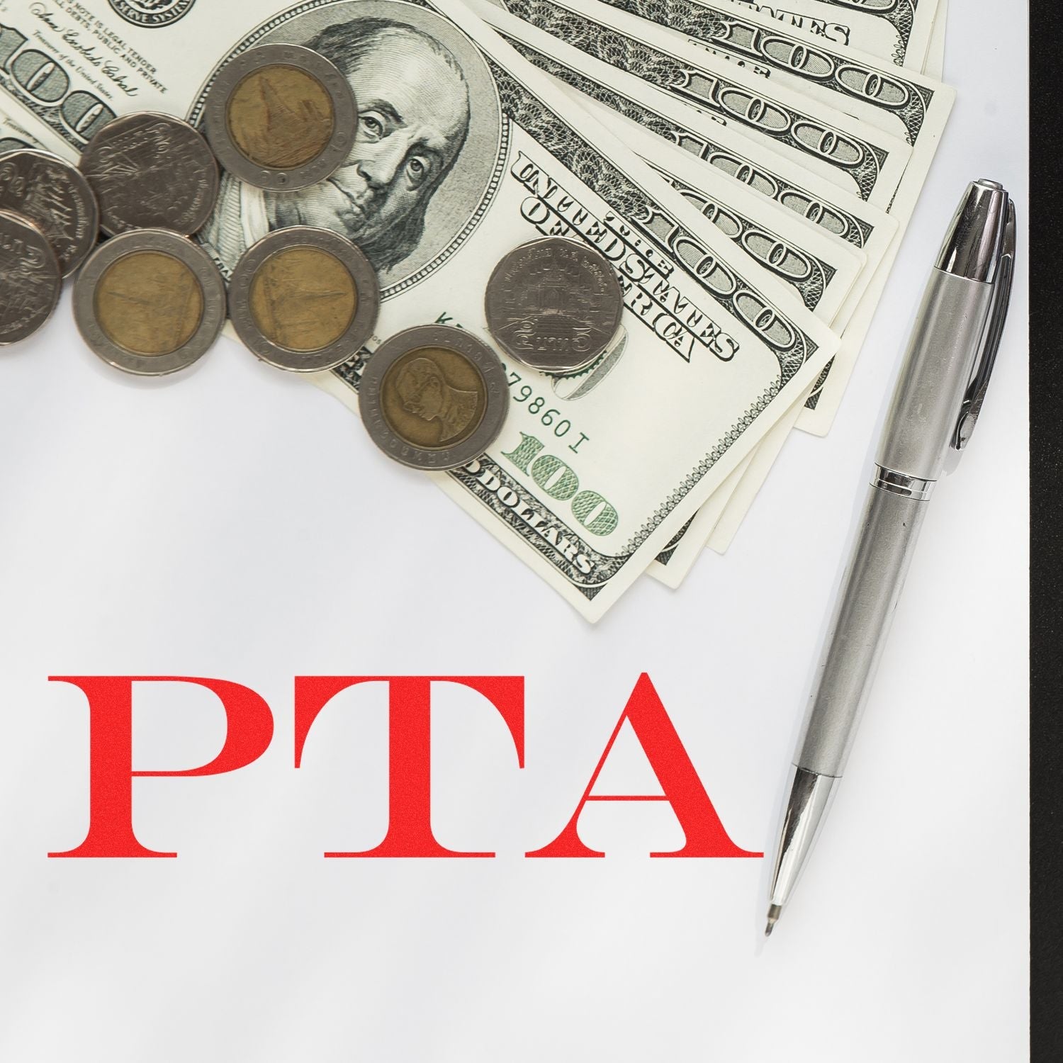 Self Inking PTA Stamp on paper with a pen, coins, and dollar bills in the background.