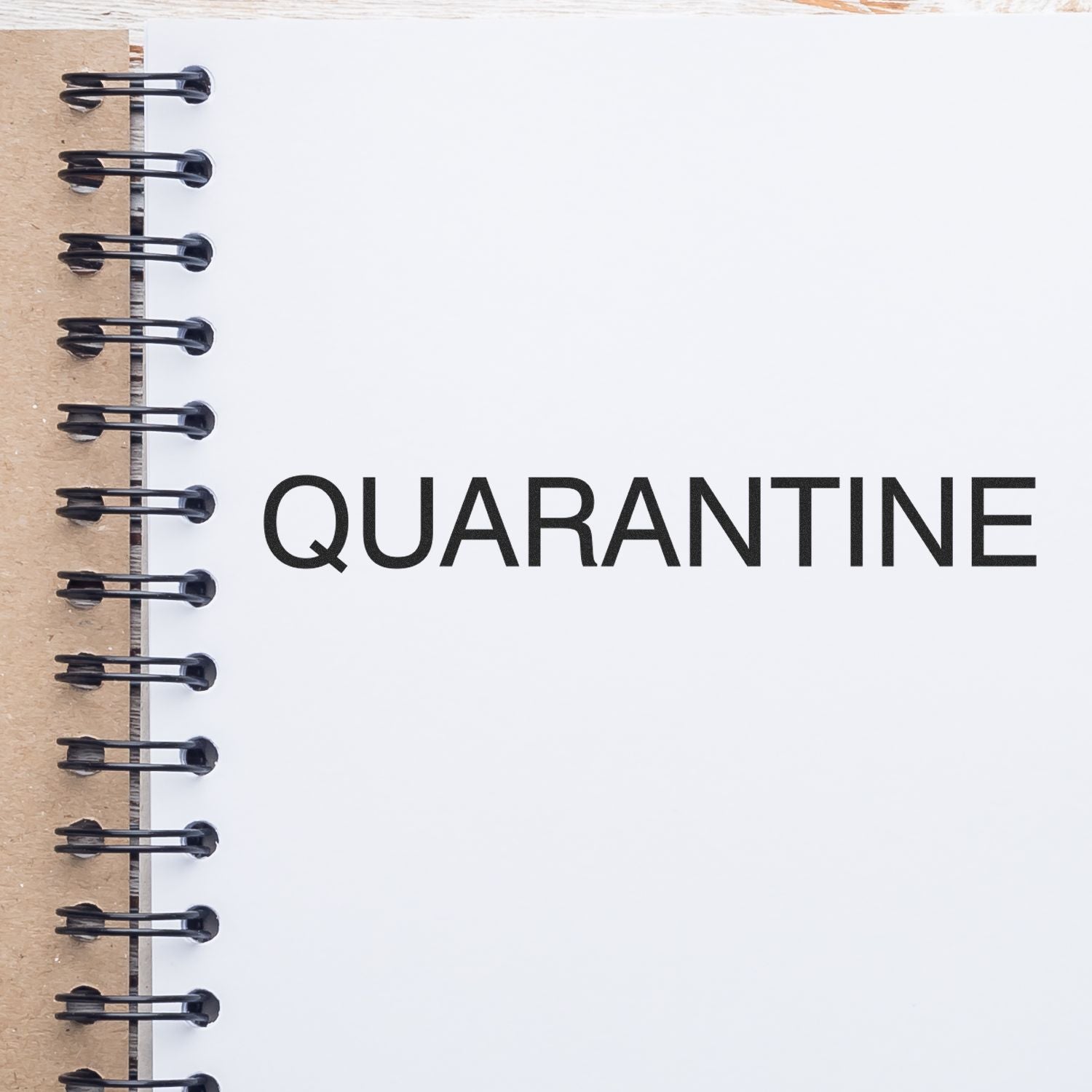 Slim Pre-Inked Quarantine Stamp used on a white notebook page with the word QUARANTINE stamped in bold black letters.