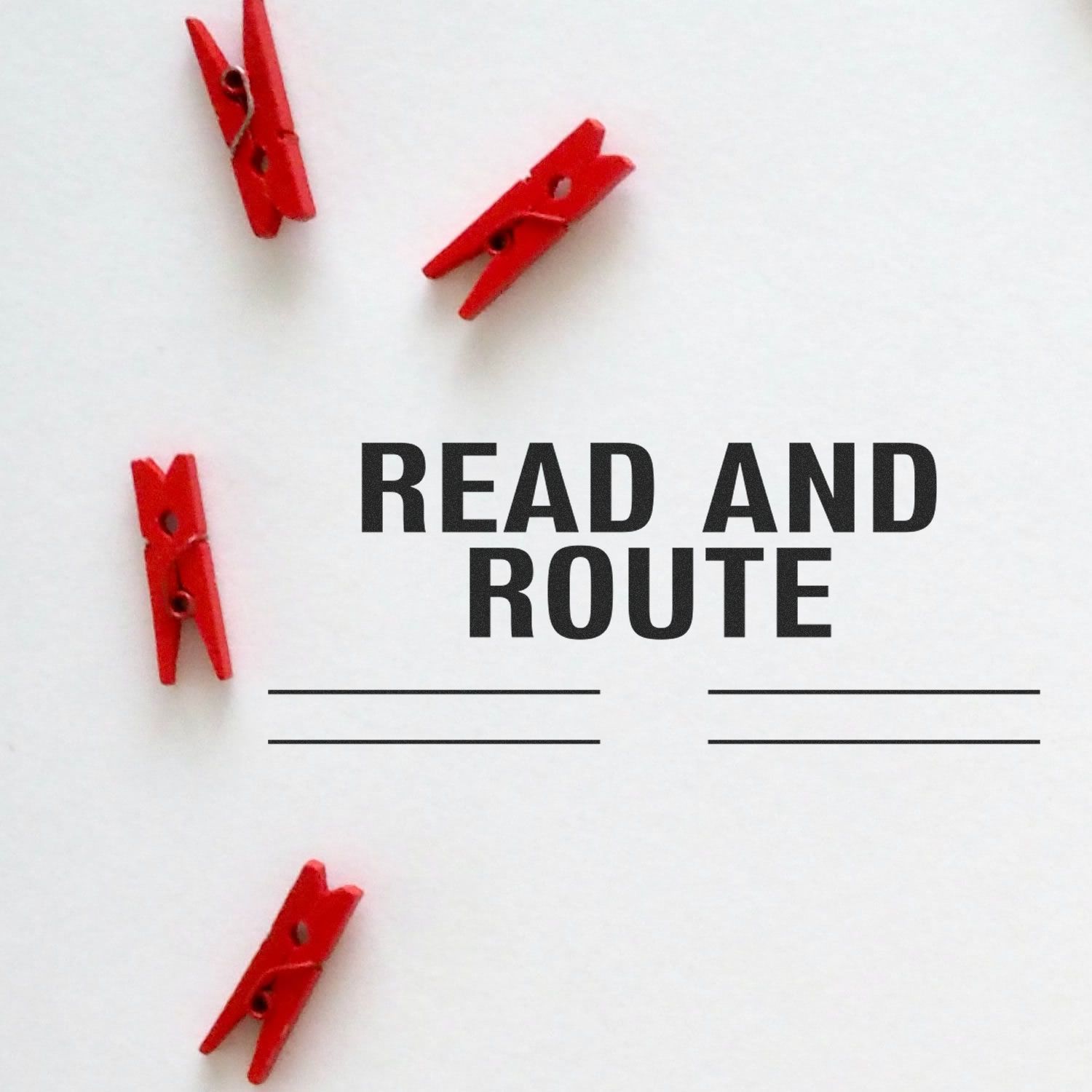 Self Inking Read and Route with Lines Stamp in use, featuring red clothespins on a white background with text and lines for routing.