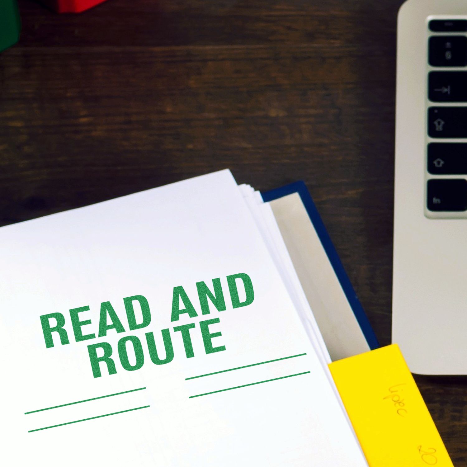 Large Read and Route with Lines Rubber Stamp used on a document, placed on a wooden desk next to a laptop and a yellow sticky note.