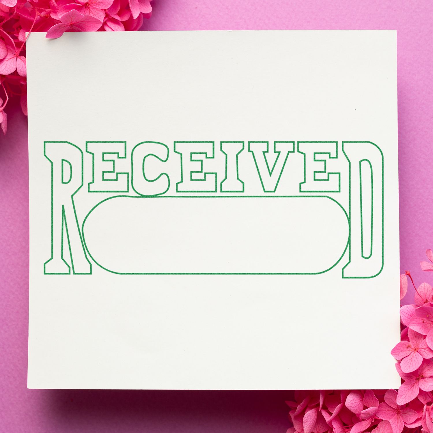 Self Inking Received with Date Box Stamp imprint on white paper with pink flowers on a pink background.