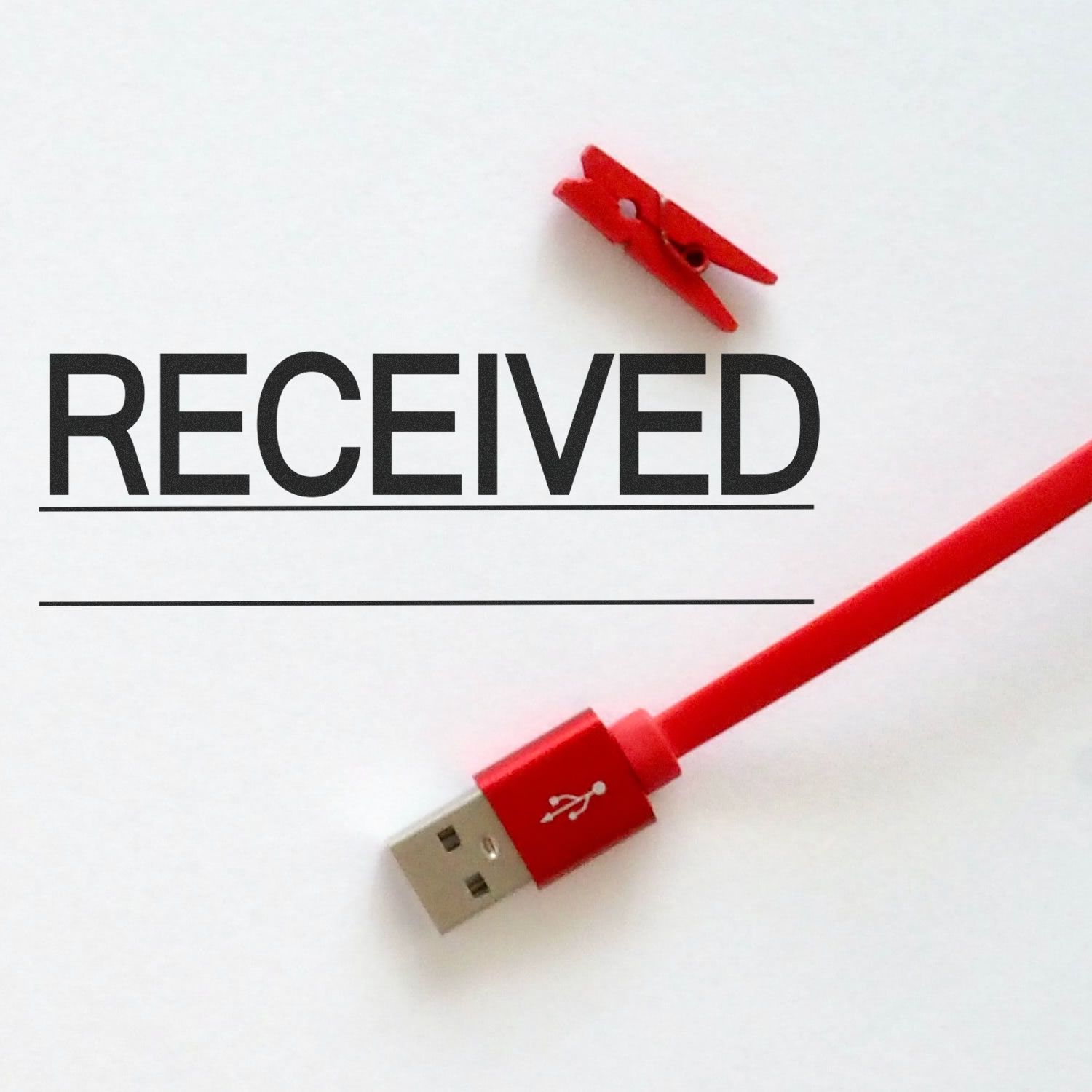 Received with Line Rubber Stamp on white paper, accompanied by a red USB cable and a red clothespin.