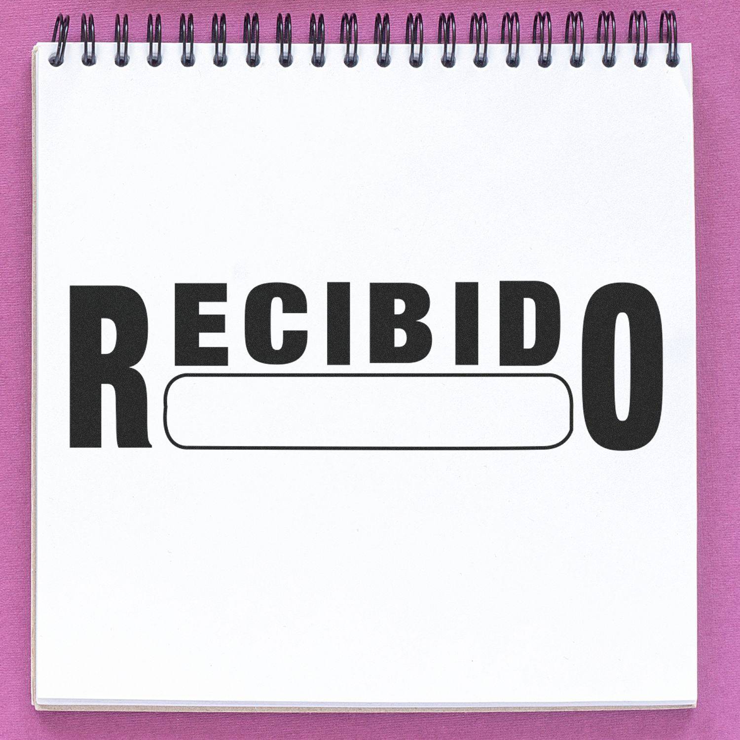 Large Recibido Rubber Stamp in use on a white notepad with a purple background. The stamp prints RECIBIDO in bold black letters.