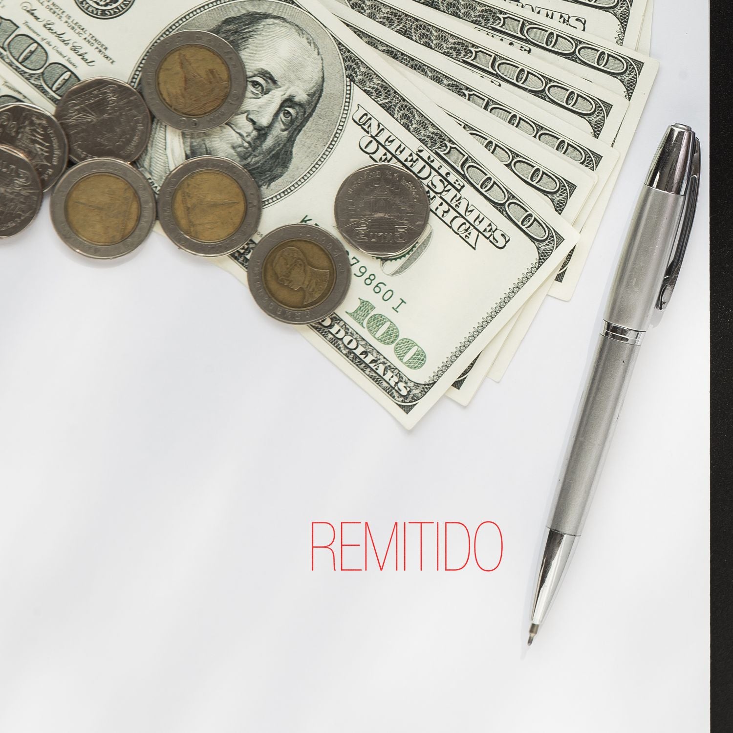 Remitido Rubber Stamp used on a document with a pen, US dollar bills, and coins placed around it."