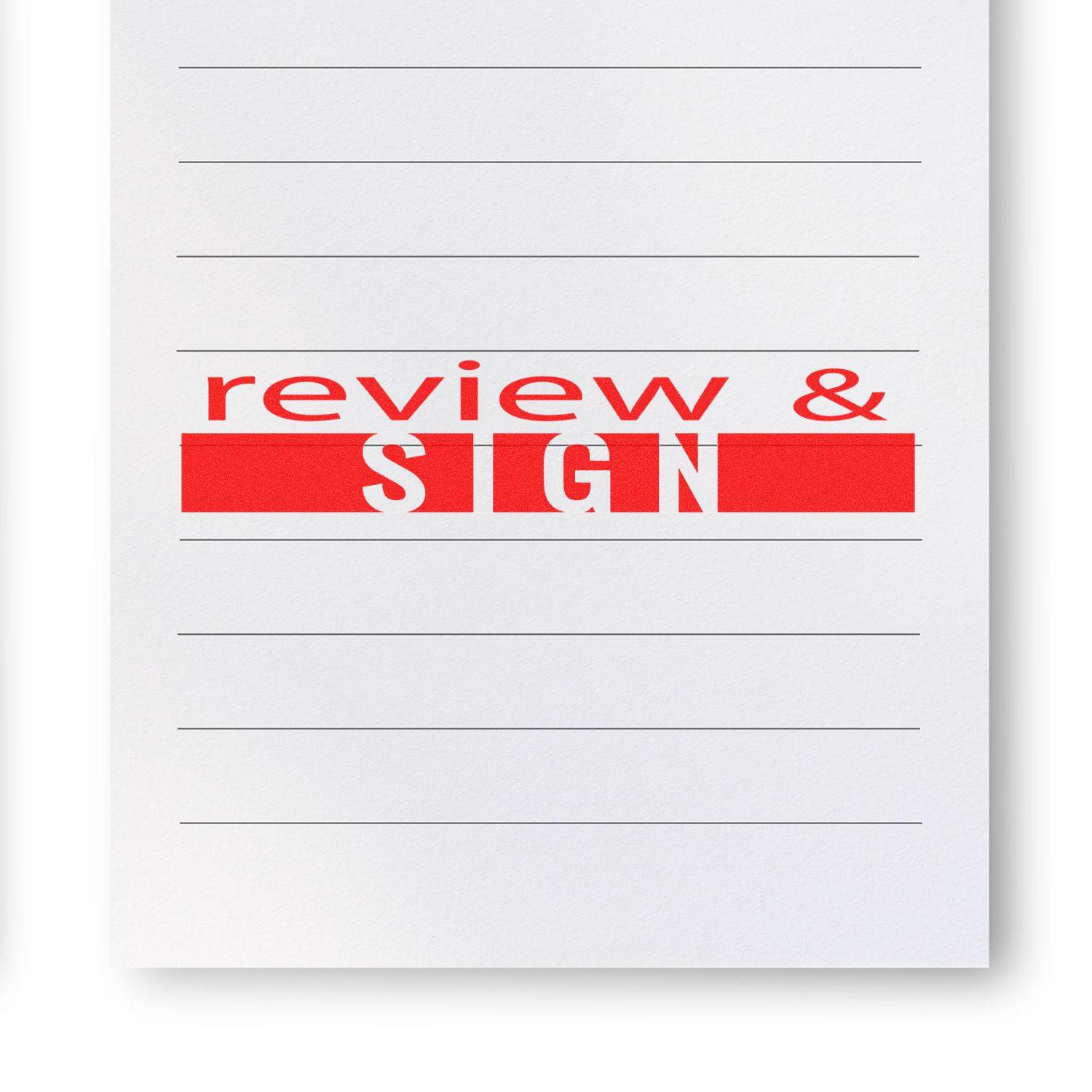 Large Review and Sign Rubber Stamp imprint in red ink on a lined white paper, indicating a document needs to be reviewed and signed.