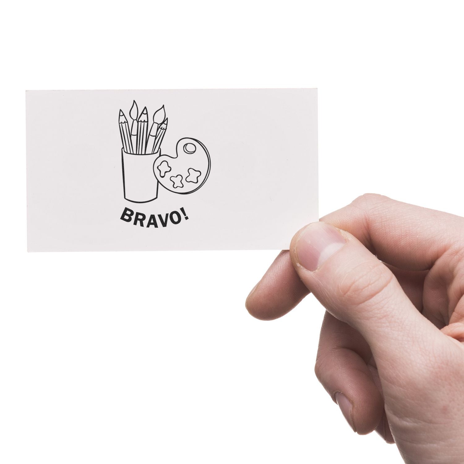 Hand holding a card stamped with the Self Inking Round Bravo Stamp, featuring art supplies and the word BRAVO!