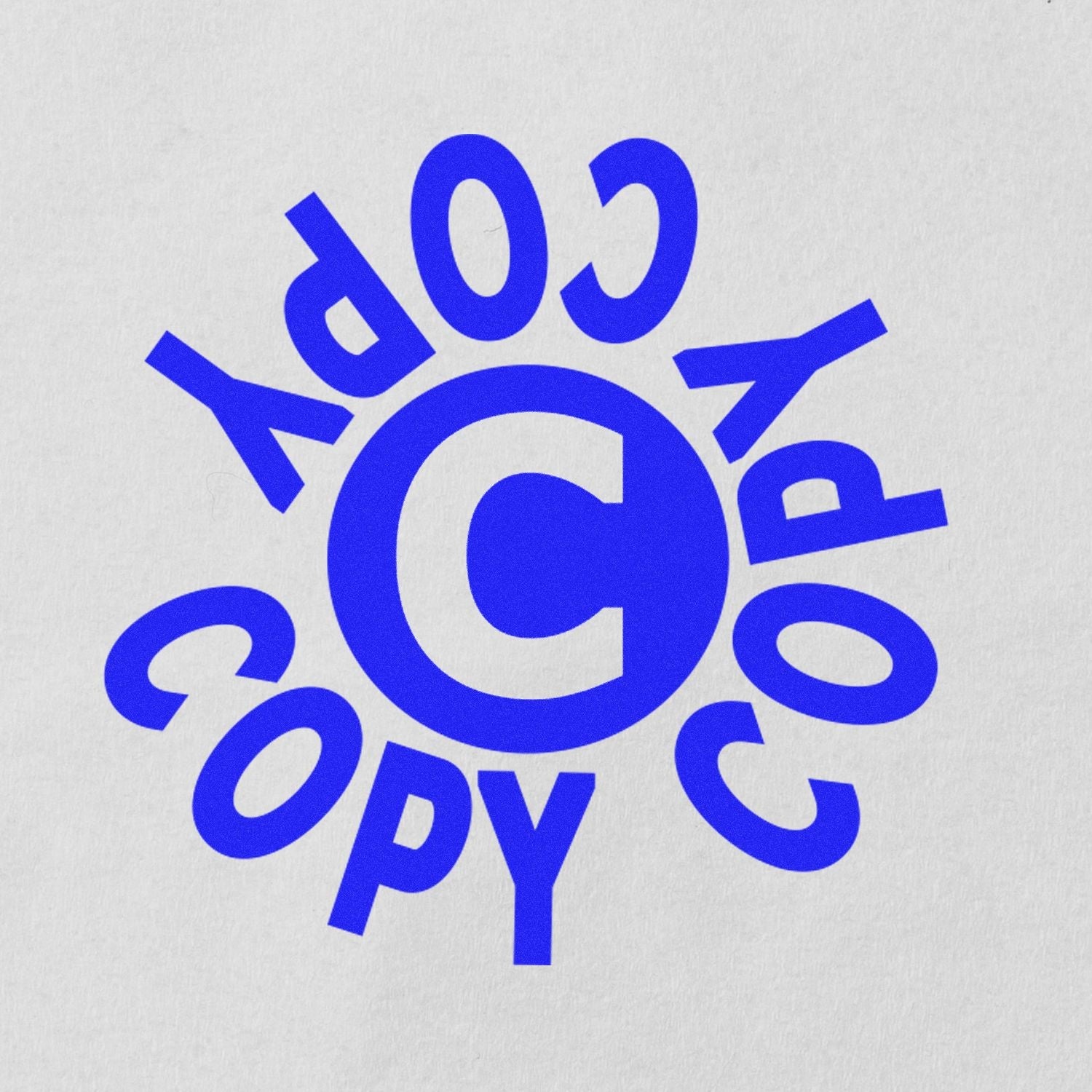 Self Inking Round Copy Copy Copy Stamp imprint in blue ink on white paper, showing the word COPY repeated in a circular pattern.