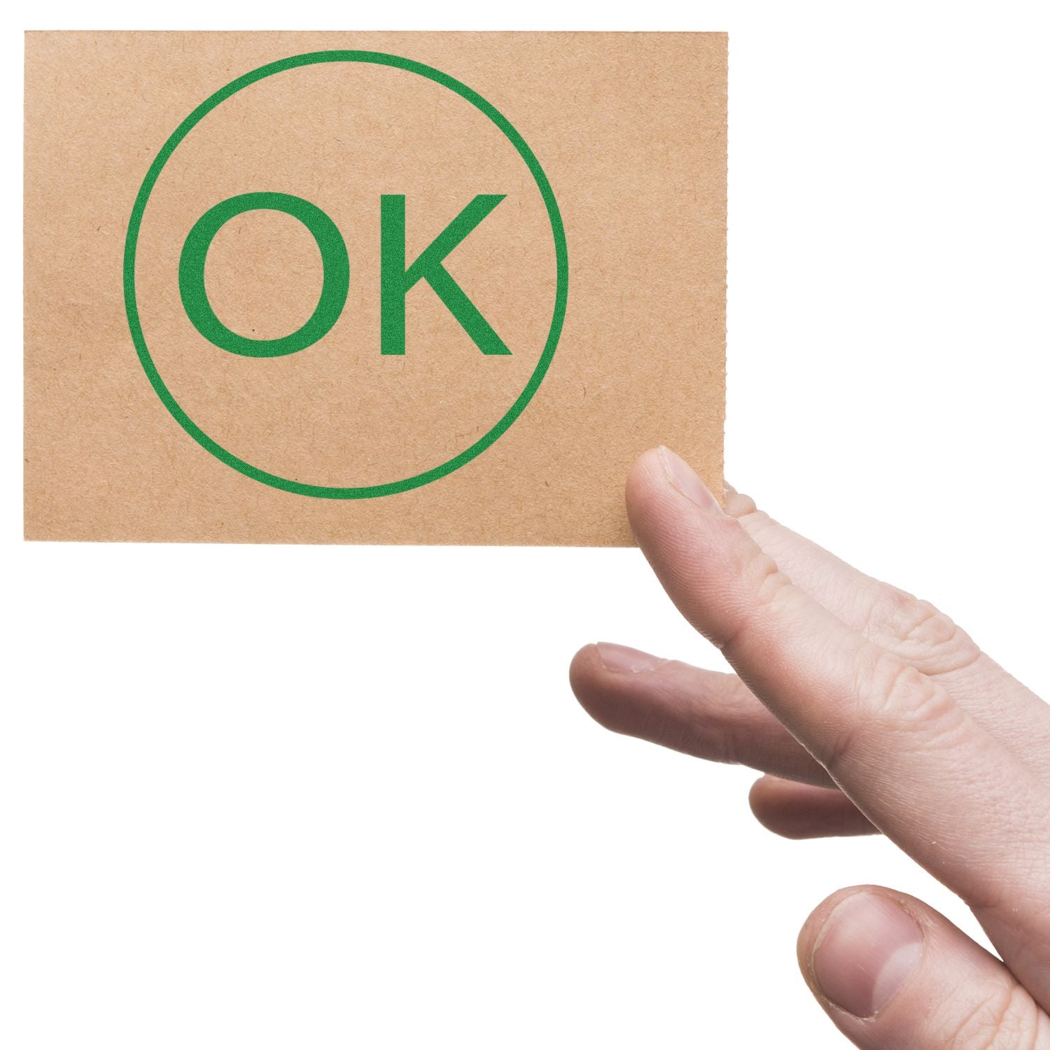 Hand holding a card stamped with a green "OK" using the Round OK Rubber Stamp.