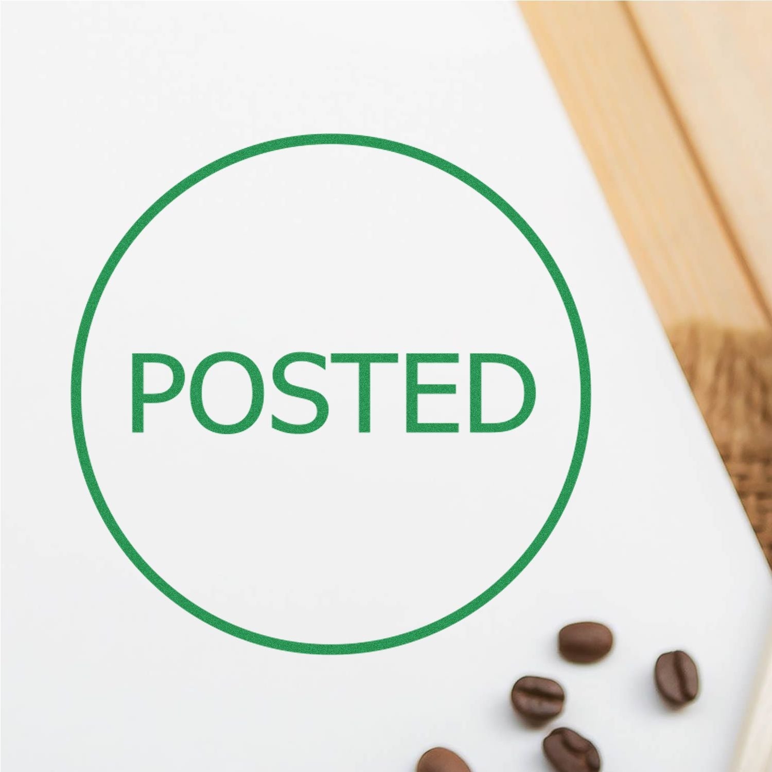 Self Inking Round Posted Stamp in green ink on white paper, with coffee beans scattered on the side, and a wooden surface in the background.