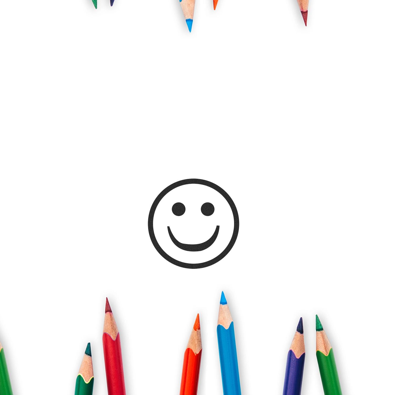 Round Smiley Rubber Stamp in the center with colorful pencils arranged around the edges on a white background.