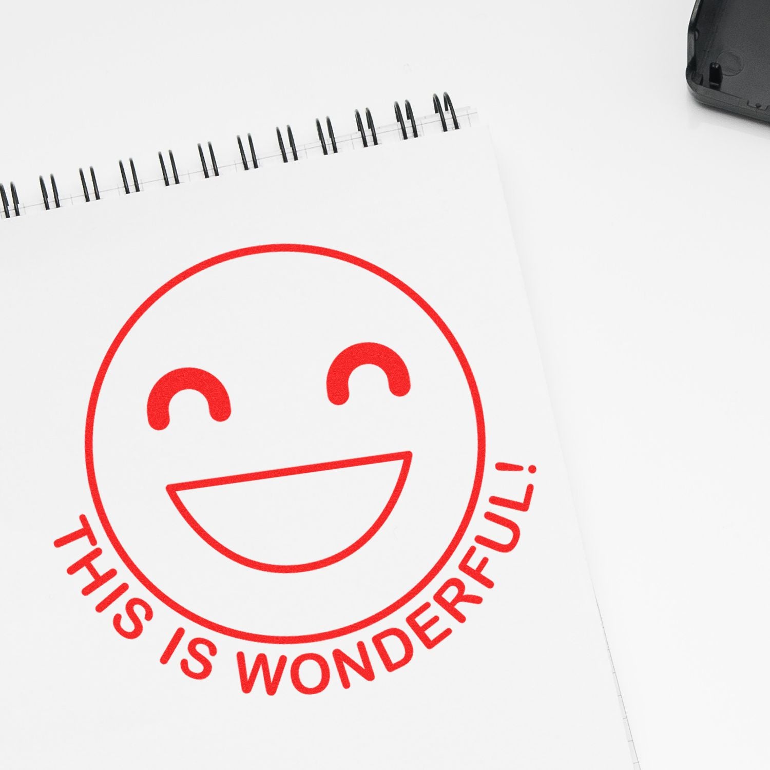 Round This is Wonderful smiley rubber stamp in red ink on a white notepad, with a black ink pad nearby.