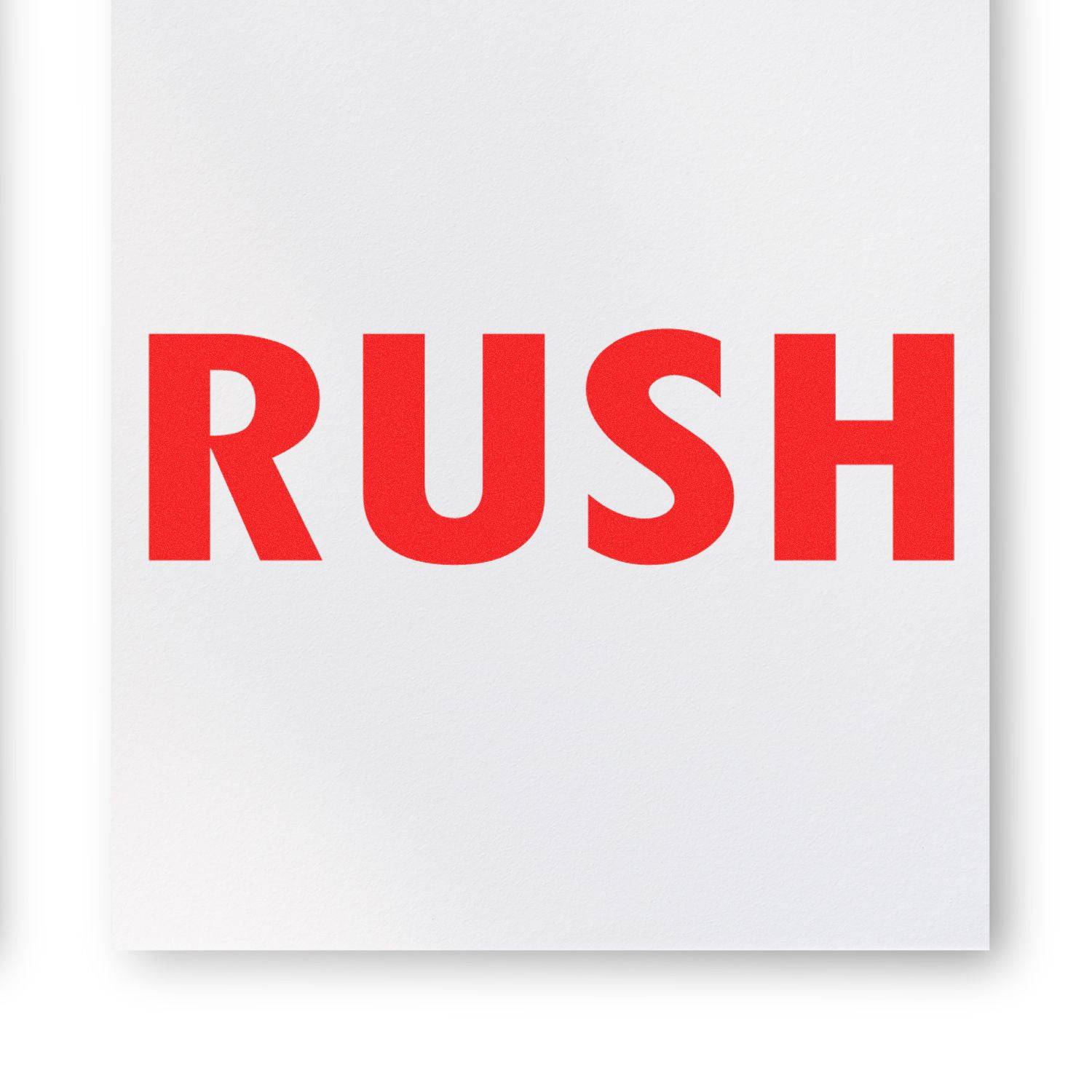 A white paper stamped with the word RUSH in bold red letters using the Large Rush Rubber Stamp.