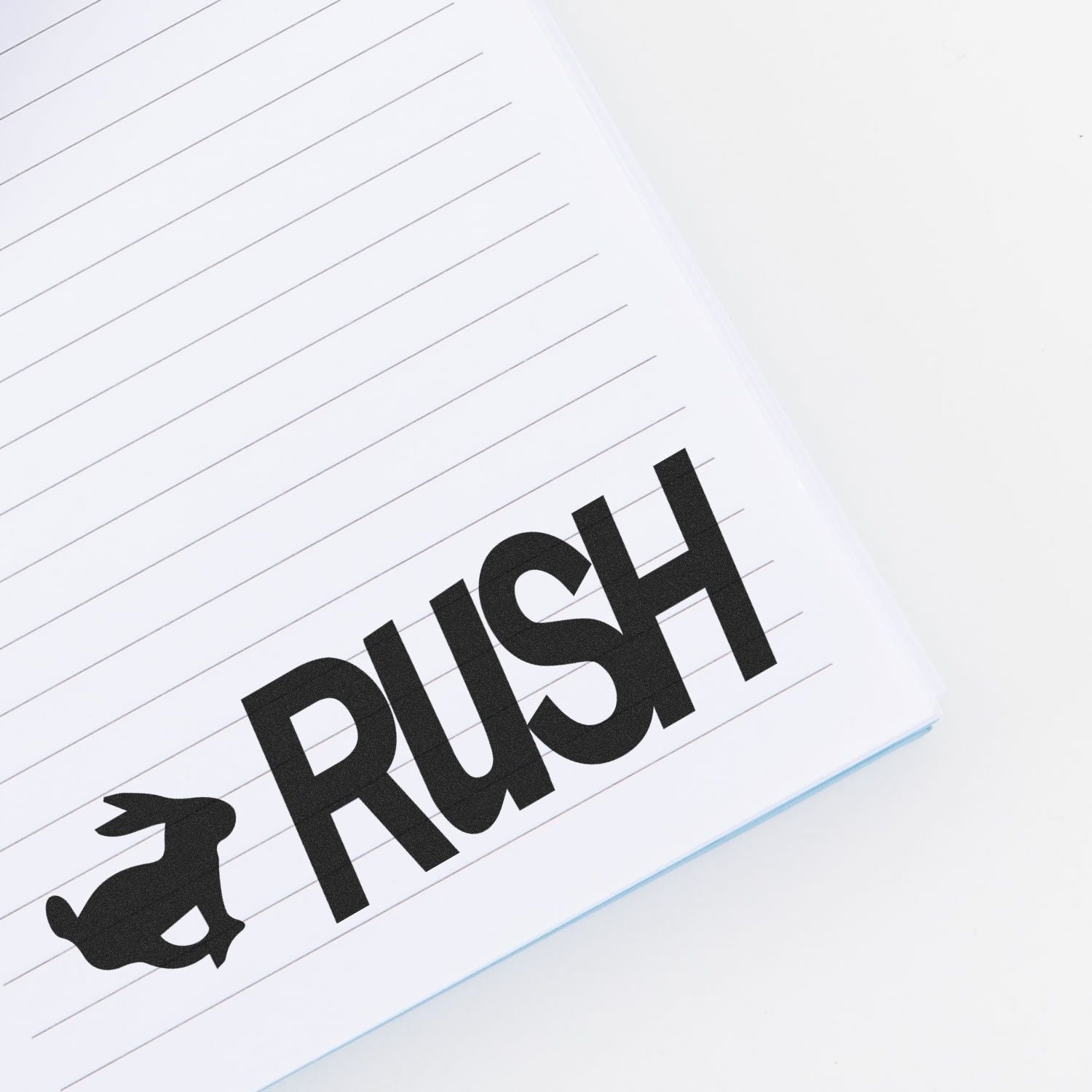 Rush with Rabbit Rubber Stamp impression on a lined notebook page, featuring a rabbit silhouette next to the word 'RUSH'.