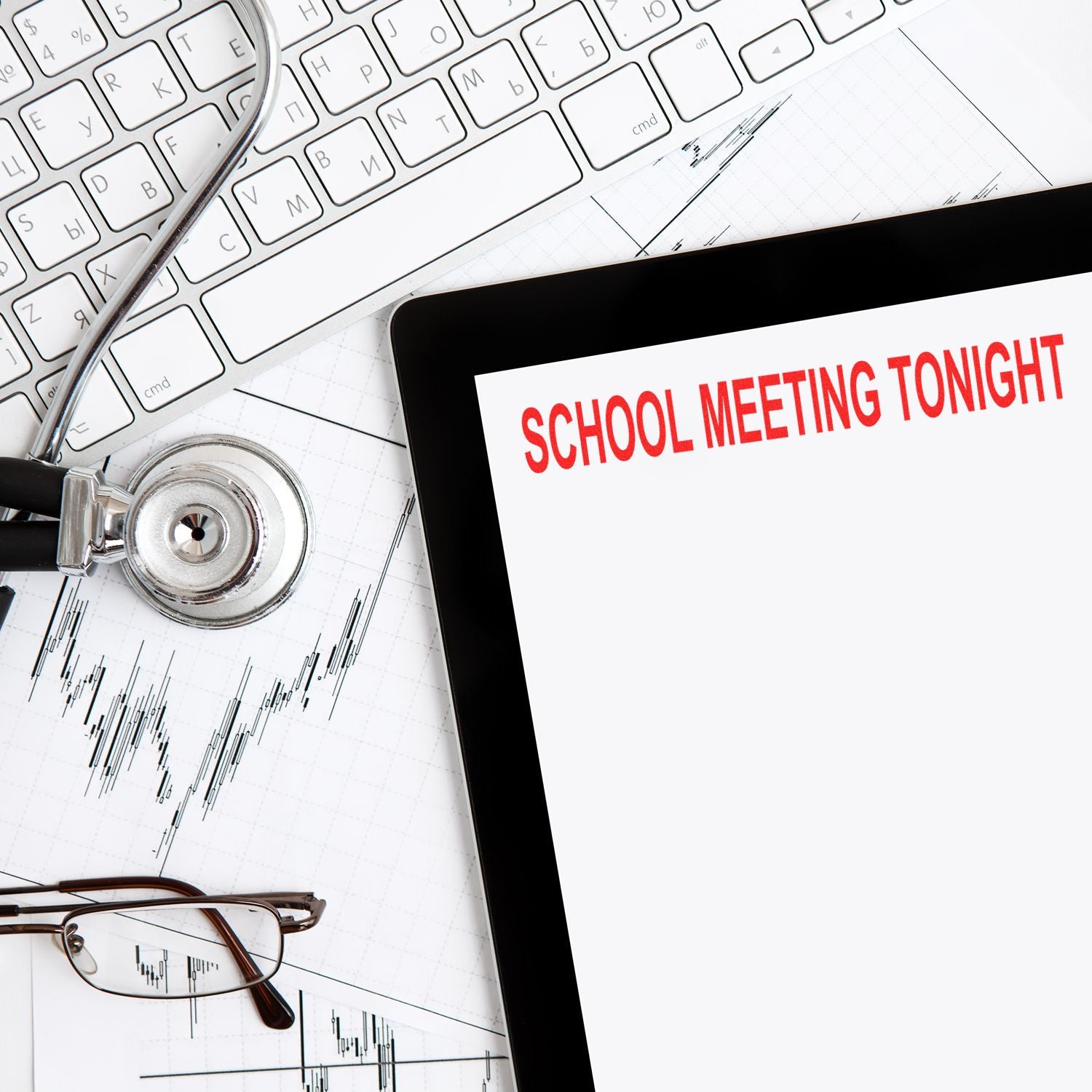 Large School Meeting Tonight Rubber Stamp used on a document next to a keyboard, stethoscope, glasses, and charts.