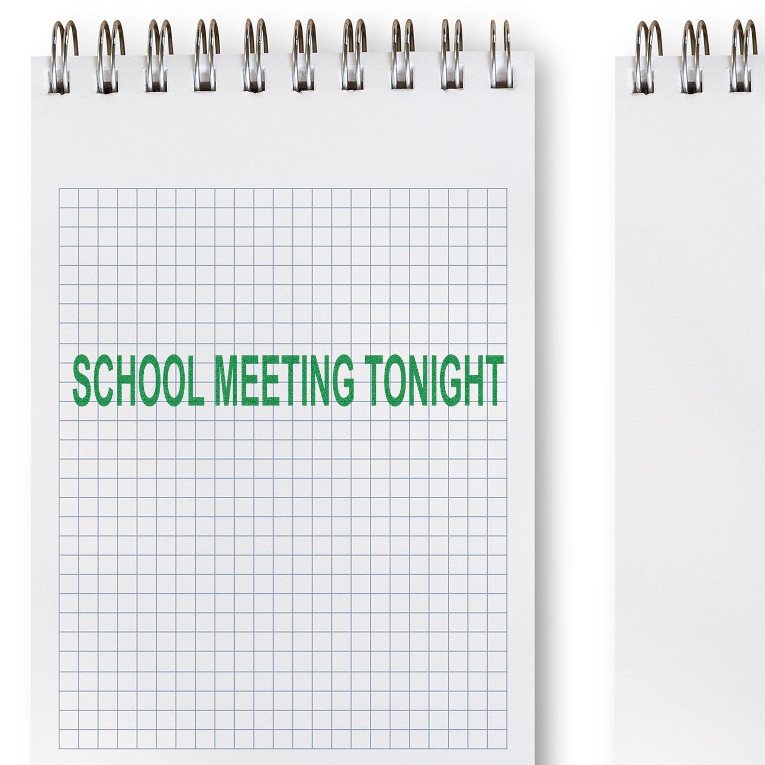 School Meeting Tonight rubber stamp impression on a spiral-bound graph paper notebook.