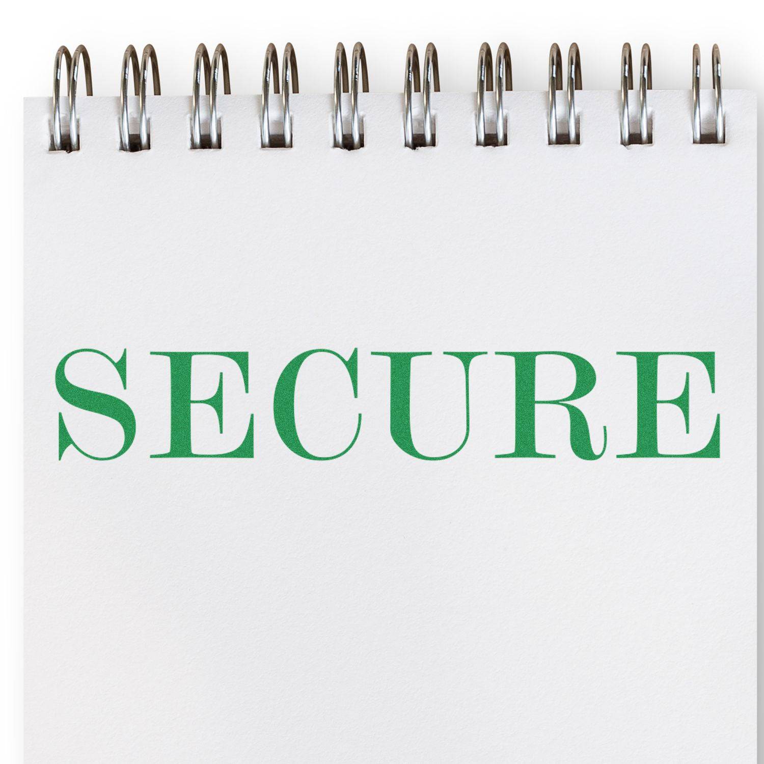 A notebook with a spiral binding displaying the word SECURE in green, stamped using the Large Secure Rubber Stamp.