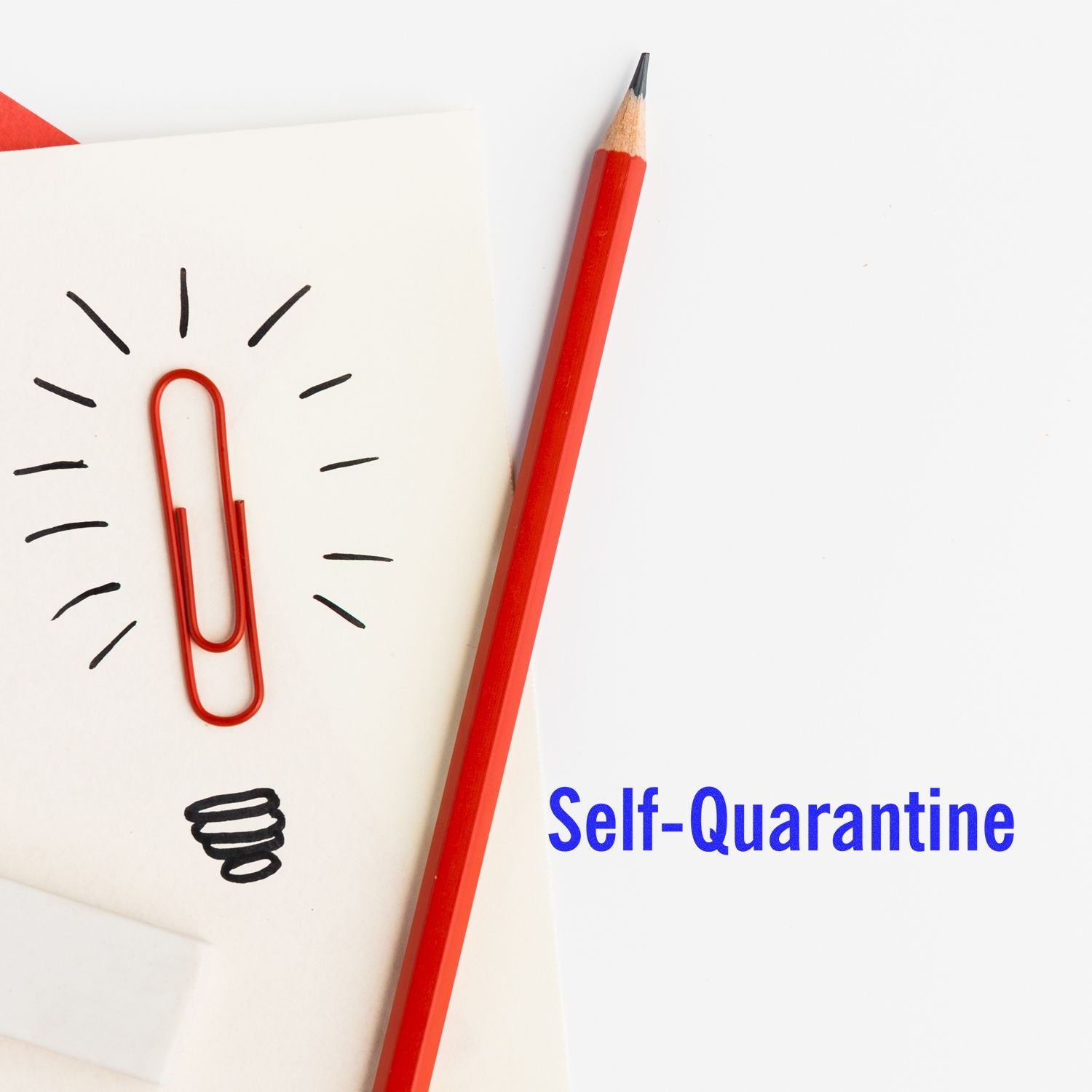 Self-Quarantine rubber stamp next to a red pencil and paperclip on a white sheet with a lightbulb doodle.