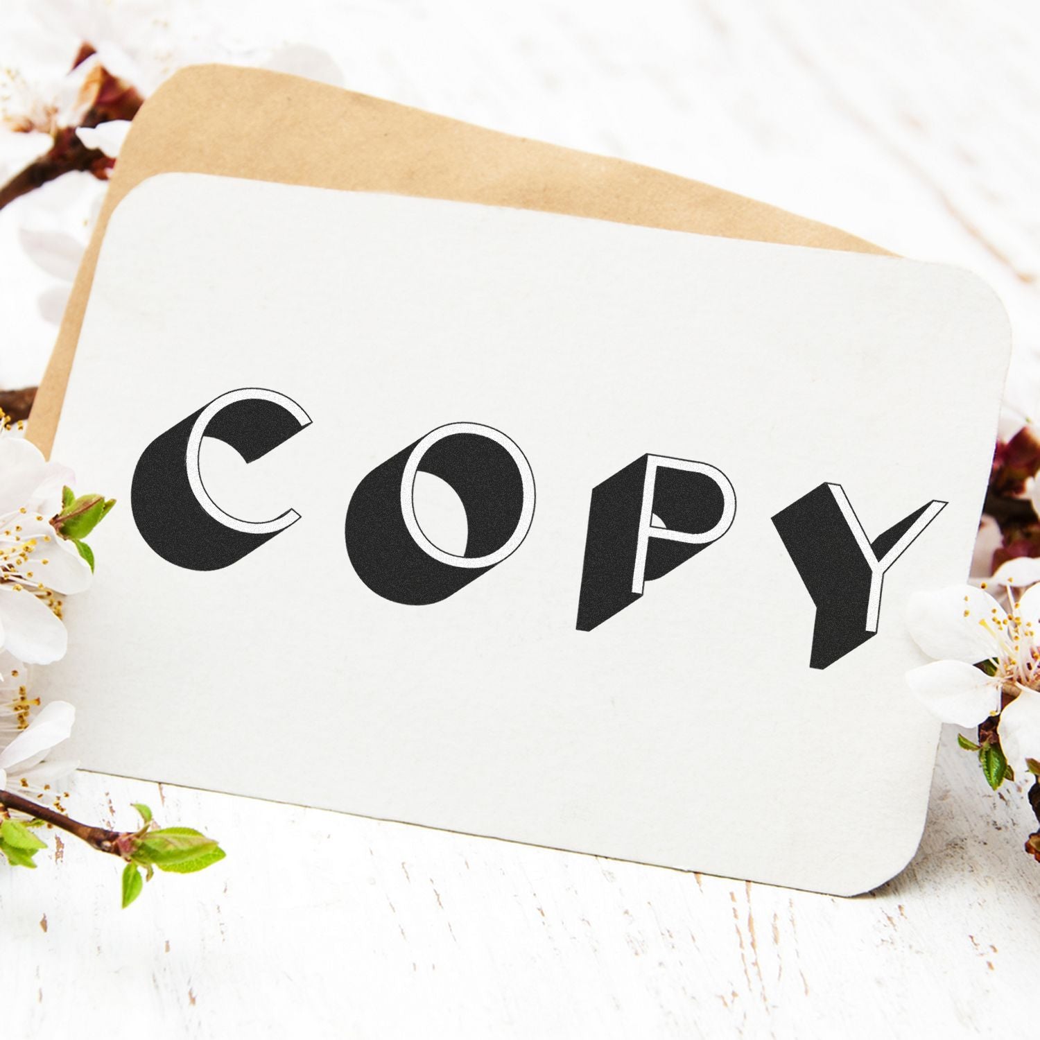 A card stamped with COPY using the Large Self Inking Shadow Copy Stamp, placed on a white surface with flowers and an envelope.