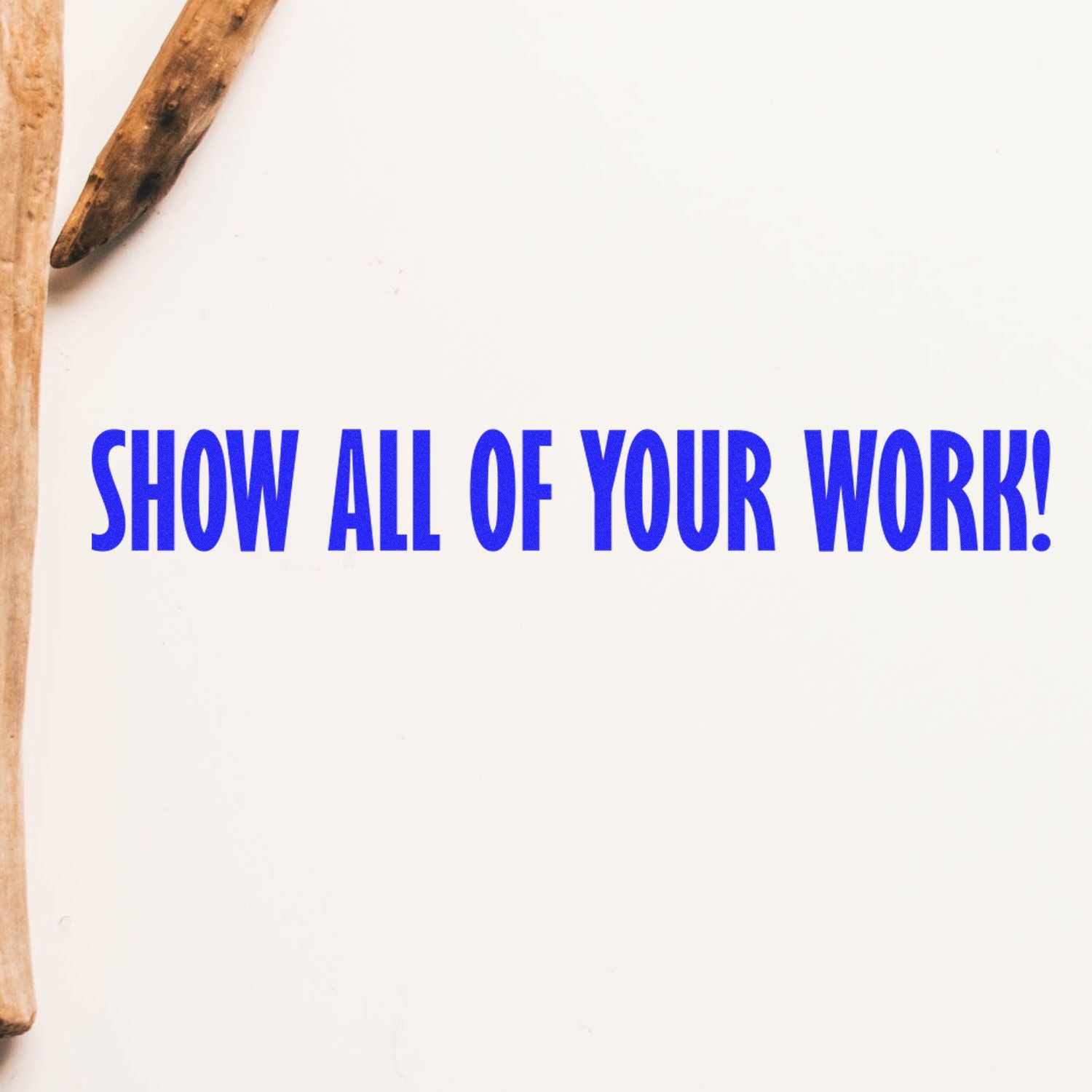 Large Show All Of Your Work rubber stamp in blue ink on white paper, with wooden handle partially visible.