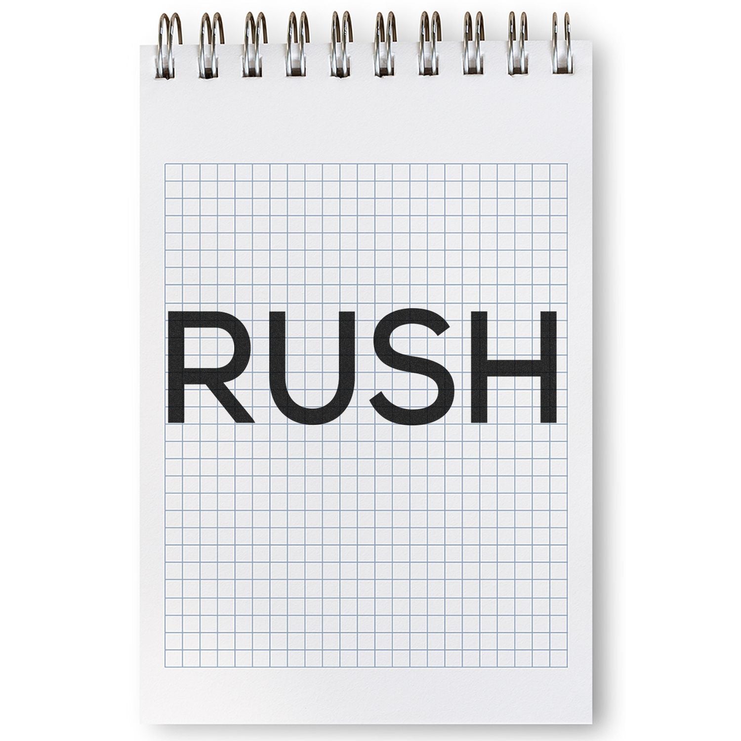 A notebook with grid paper displaying the word RUSH stamped in bold letters using a Skinny Rush Rubber Stamp.