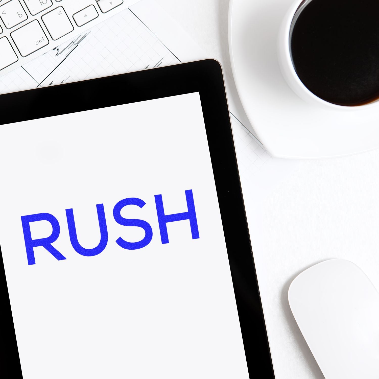 Large Self Inking Skinny Rush Stamp in use, stamping the word RUSH in blue ink on a white paper, with a keyboard and coffee cup nearby.