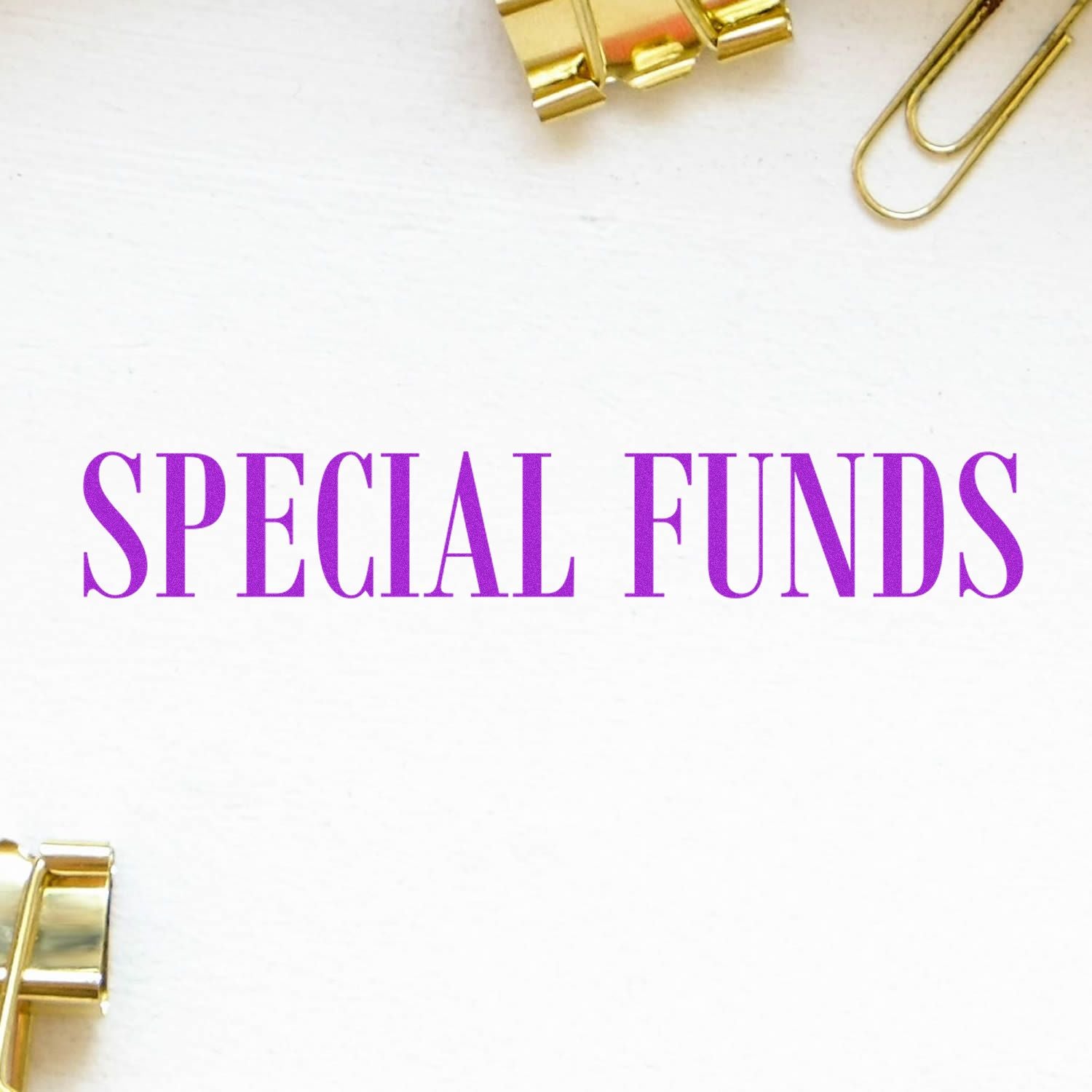 Large Special Funds rubber stamp in purple ink on white paper, surrounded by gold binder clips and paperclips.