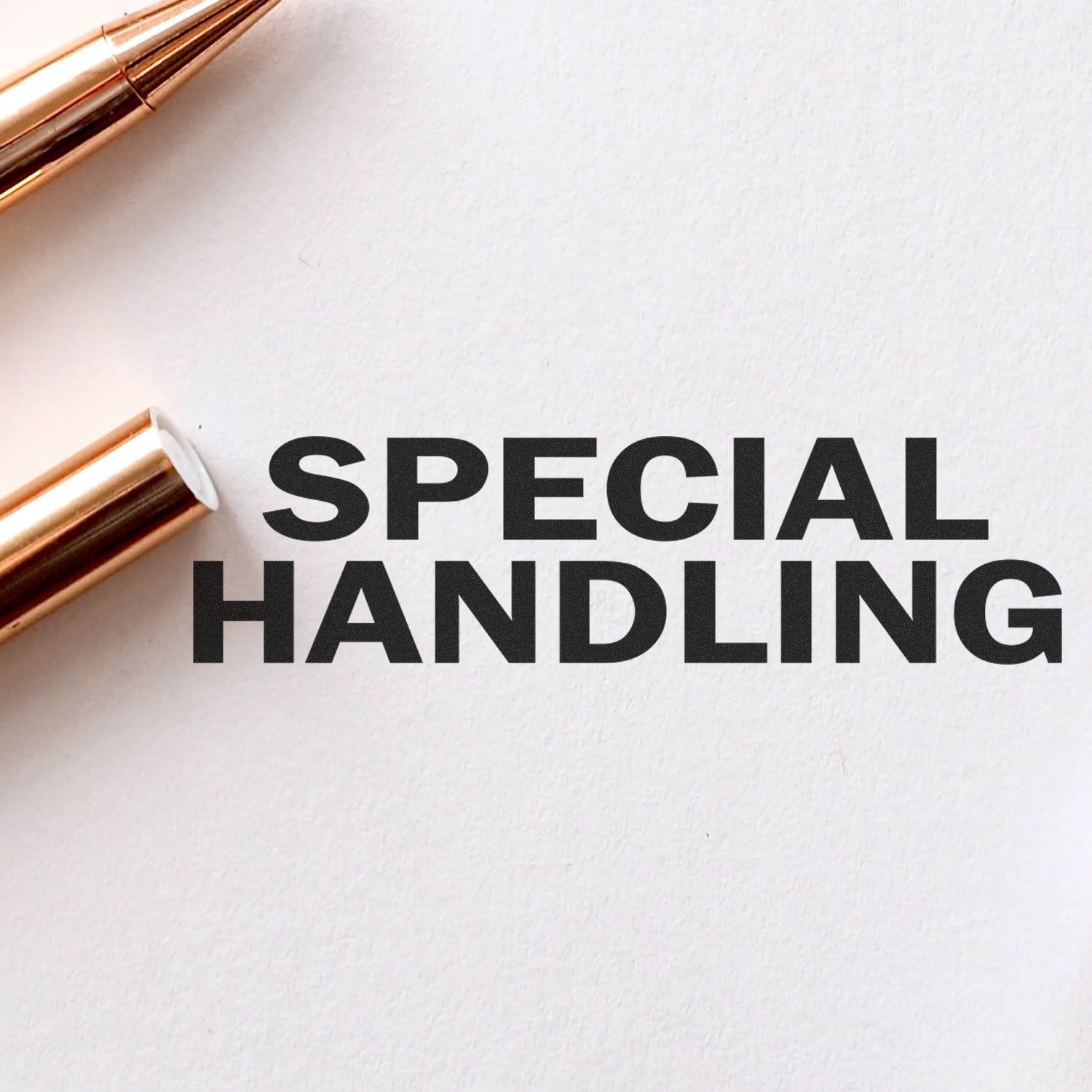 Large Special Handling Rubber Stamp imprint on white paper, next to a gold pen.