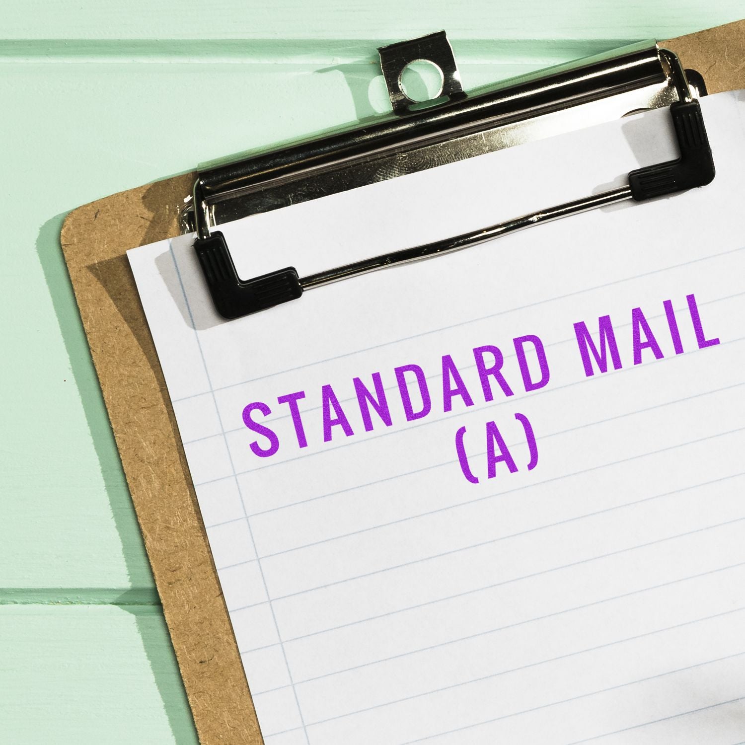 A clipboard with lined paper stamped "Standard Mail (A)" in purple ink using the Standard Mail (A) Rubber Stamp.