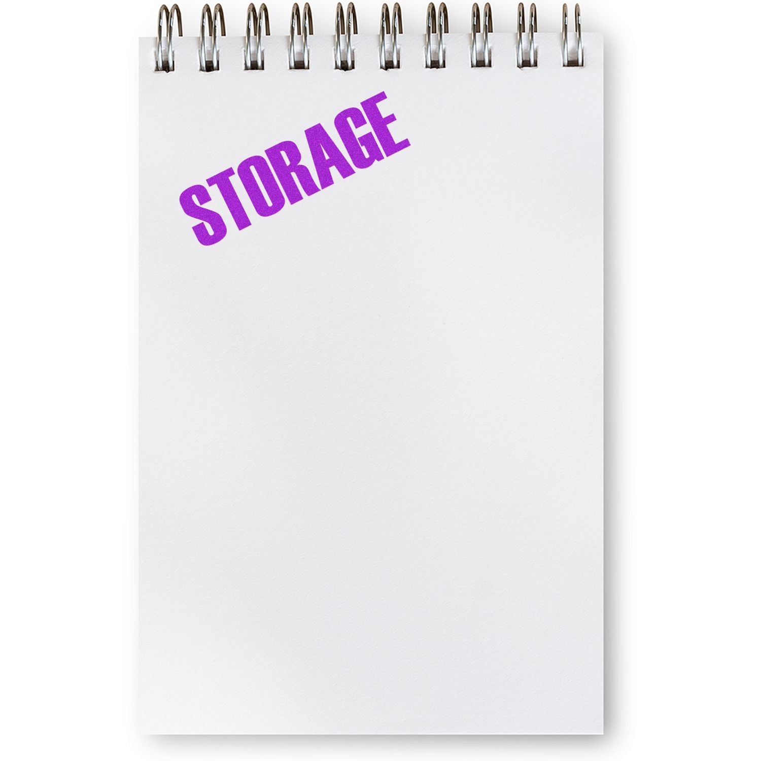 A Large Storage Rubber Stamp in purple ink is used on a blank, spiral-bound notepad.